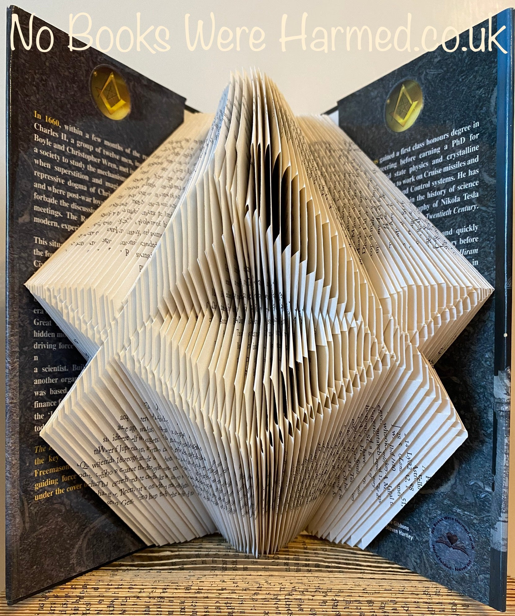 Hand-folded Square & Compass book art made from vintage pages, showcasing intricate geometric designs.