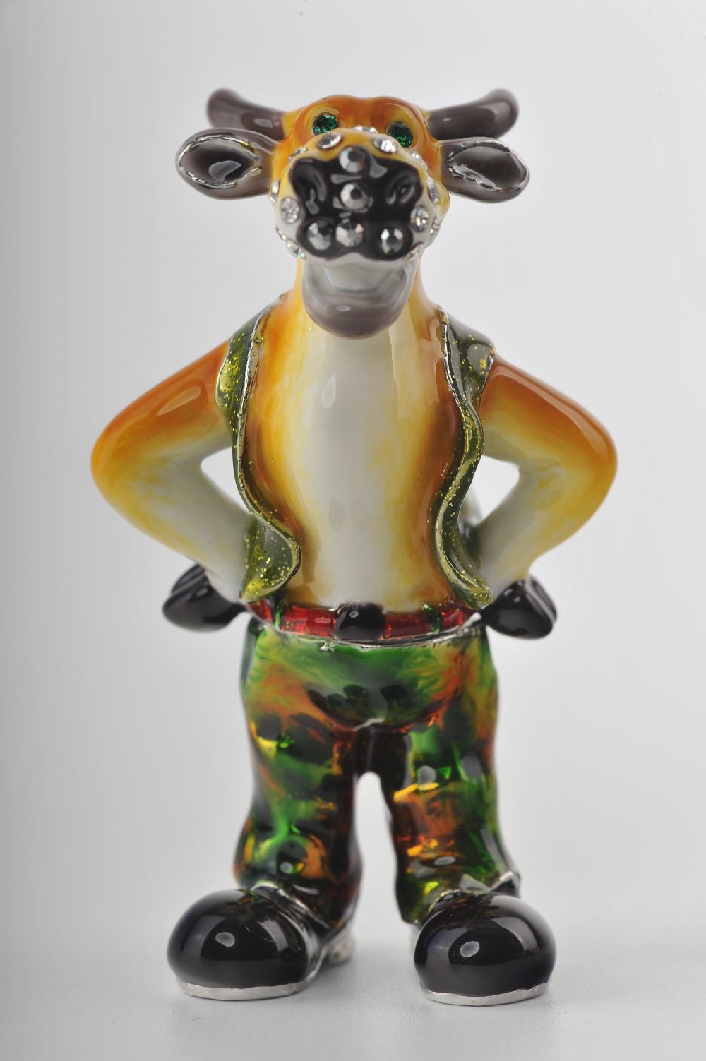 Handmade Standing Bull trinket box with green pants, adorned with Austrian crystals and 24K gold plating, elegantly displayed in a black box.