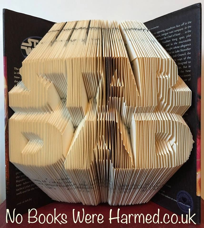 Handcrafted STAR DAD book art made from vintage books, showcasing unique folded pages in a decorative design.