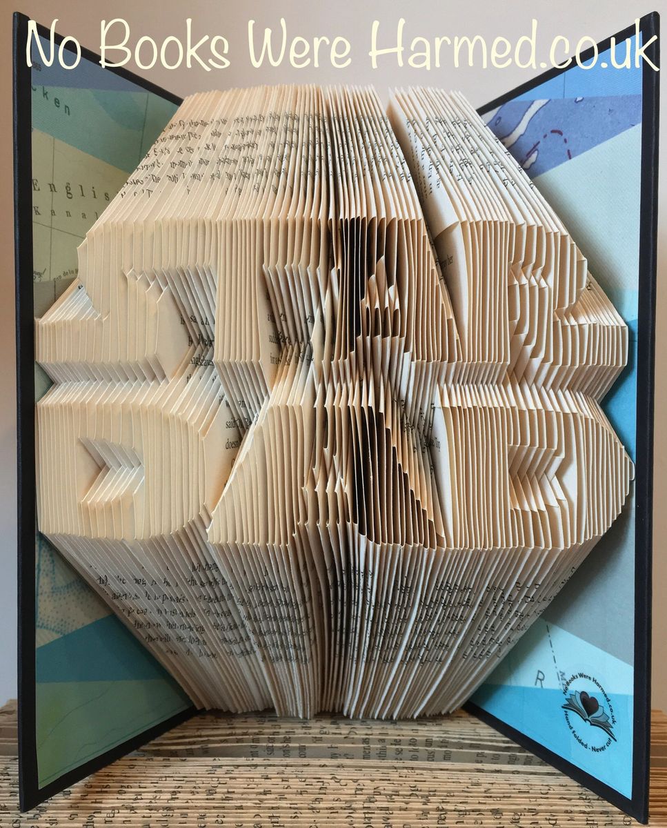 Handcrafted STAR DAD book art made from vintage books, showcasing unique folded pages in a decorative design.