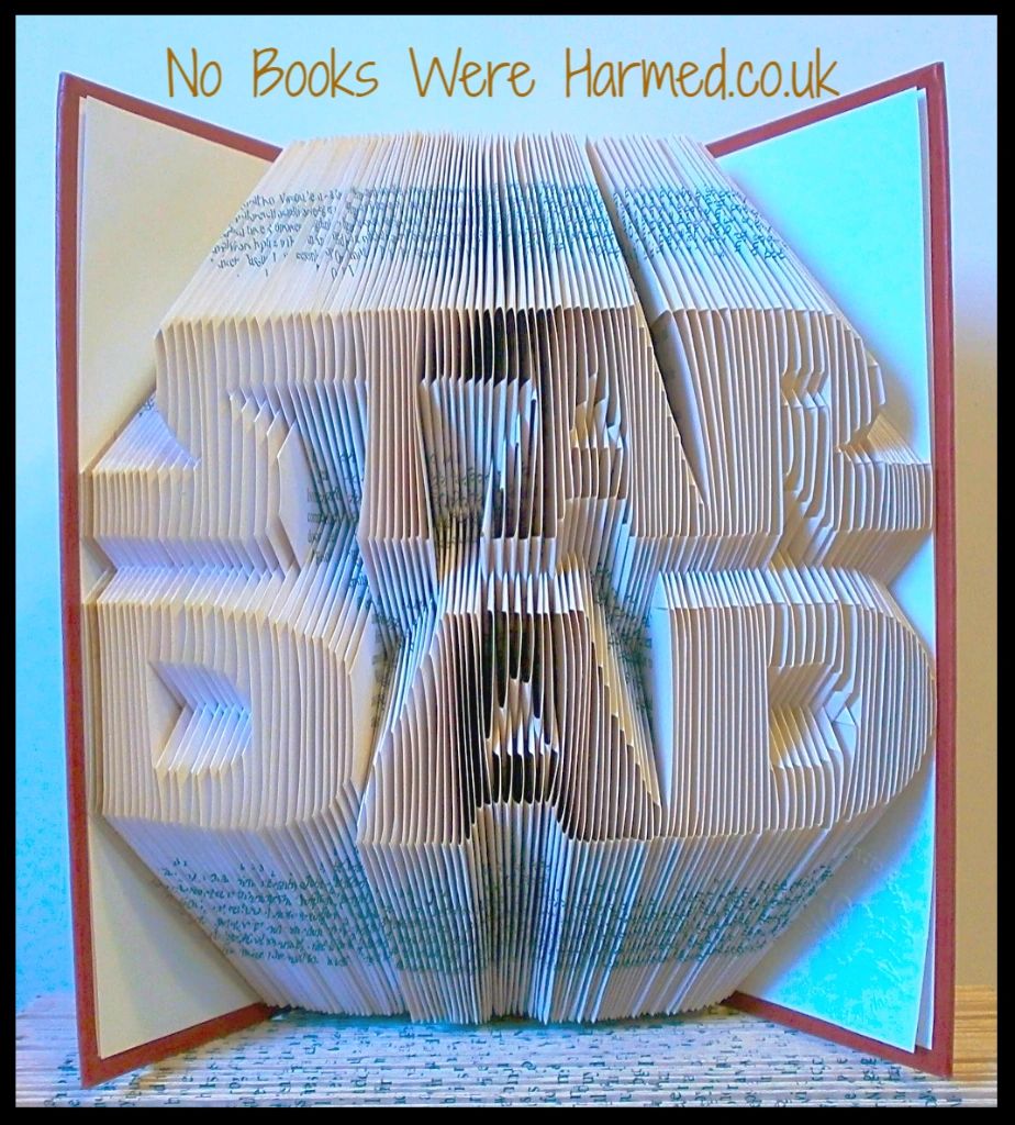 Handcrafted STAR DAD book art made from vintage books, showcasing unique folded pages in a decorative design.