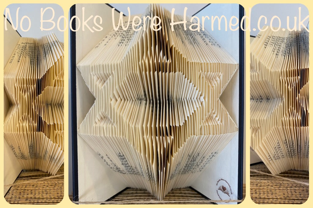 Handcrafted Star of David art made from vintage book pages, showcasing intricate folds and unique design.