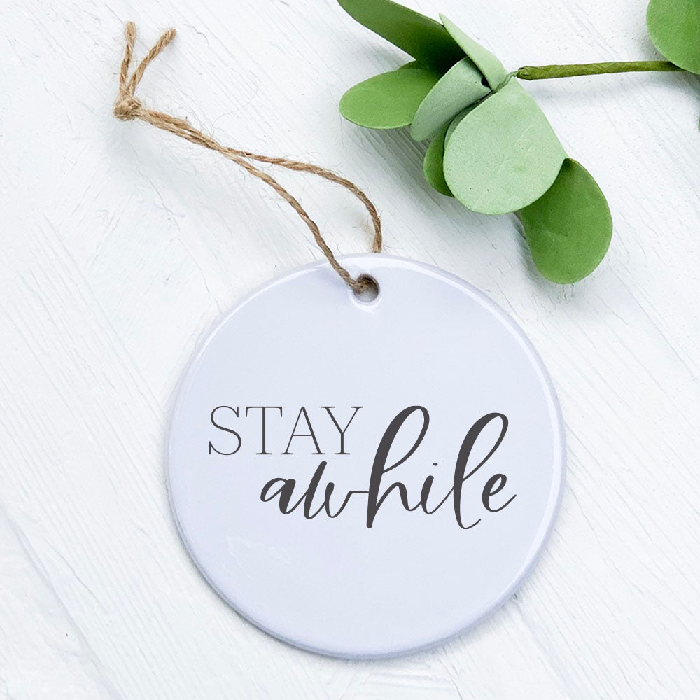 Stay Awhile porcelain ornament featuring original designs, 2.75 inches in diameter, with a smooth gloss finish.