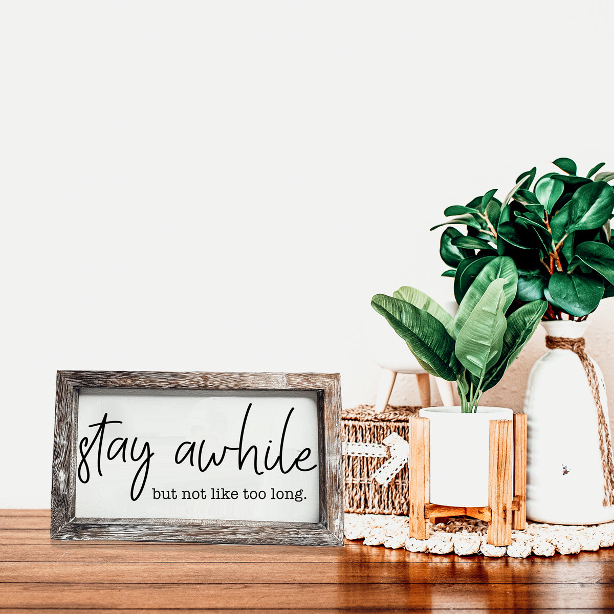 Stay Awhile Sign made of Paulownia wood featuring a humorous message, designed for wall hanging or standing display.