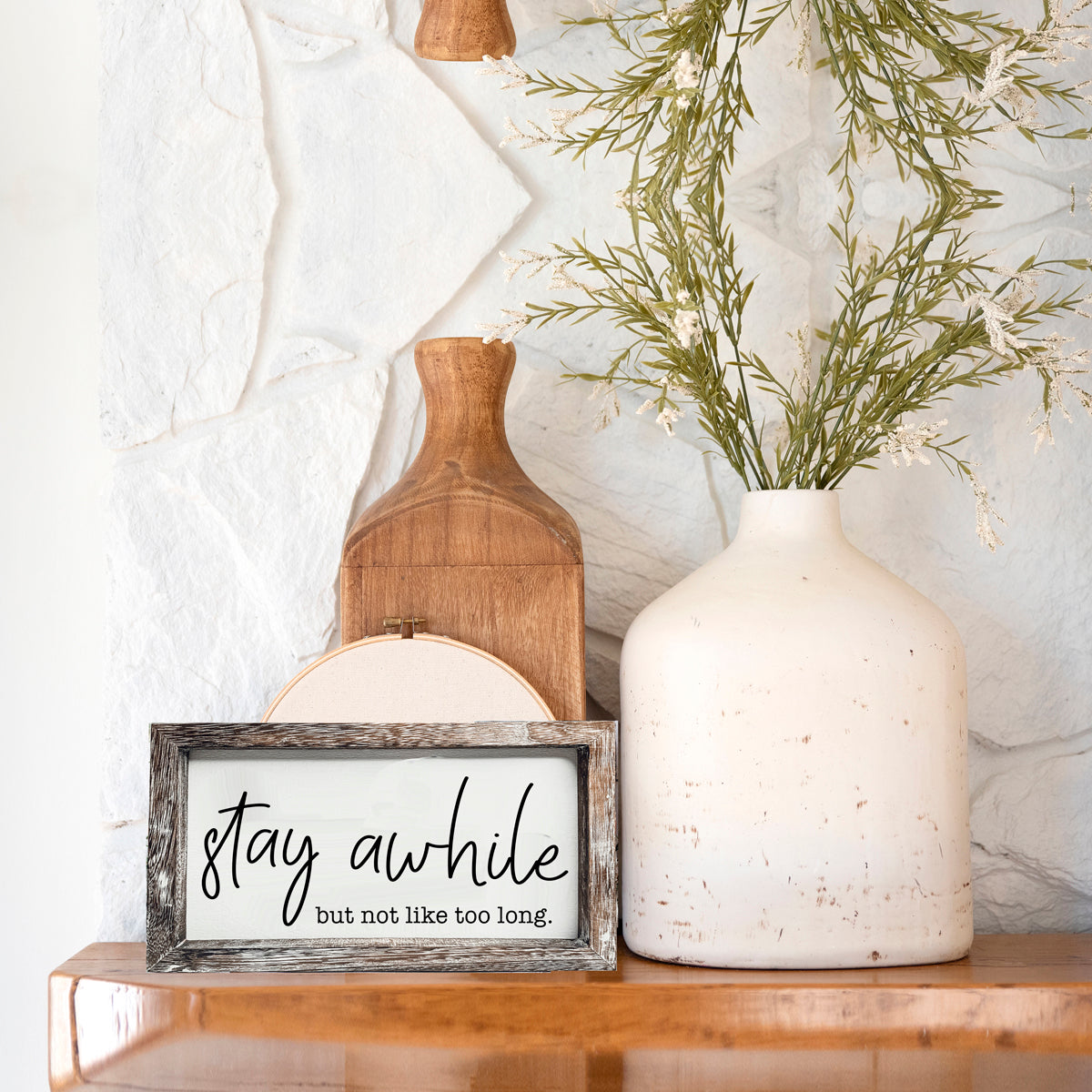 Stay Awhile Sign made of Paulownia wood featuring a humorous message, designed for wall hanging or standing display.