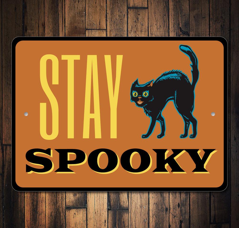 A decorative Stay Spooky Sign made of aluminum, featuring spooky Halloween-themed graphics, perfect for home decor.