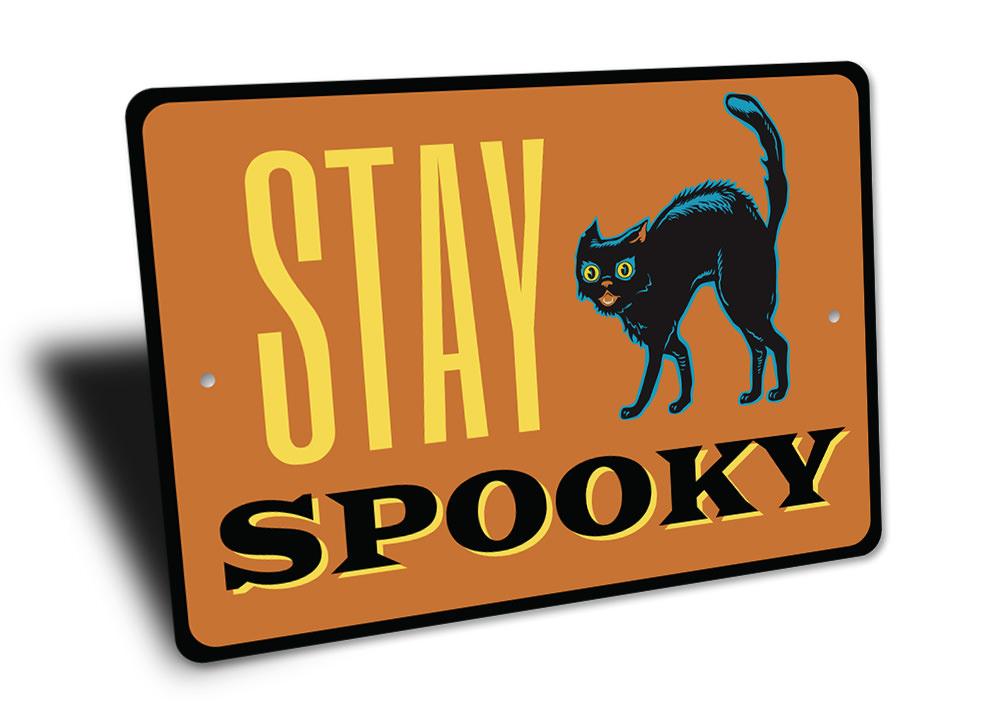 A decorative Stay Spooky Sign made of aluminum, featuring spooky Halloween-themed graphics, perfect for home decor.