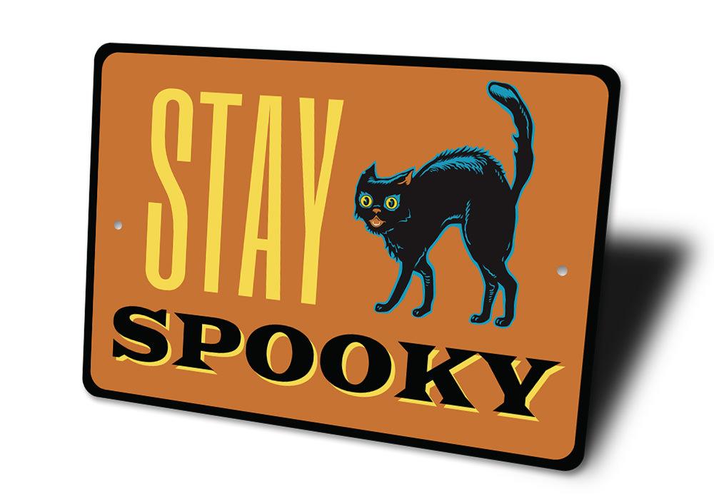 A decorative Stay Spooky Sign made of aluminum, featuring spooky Halloween-themed graphics, perfect for home decor.