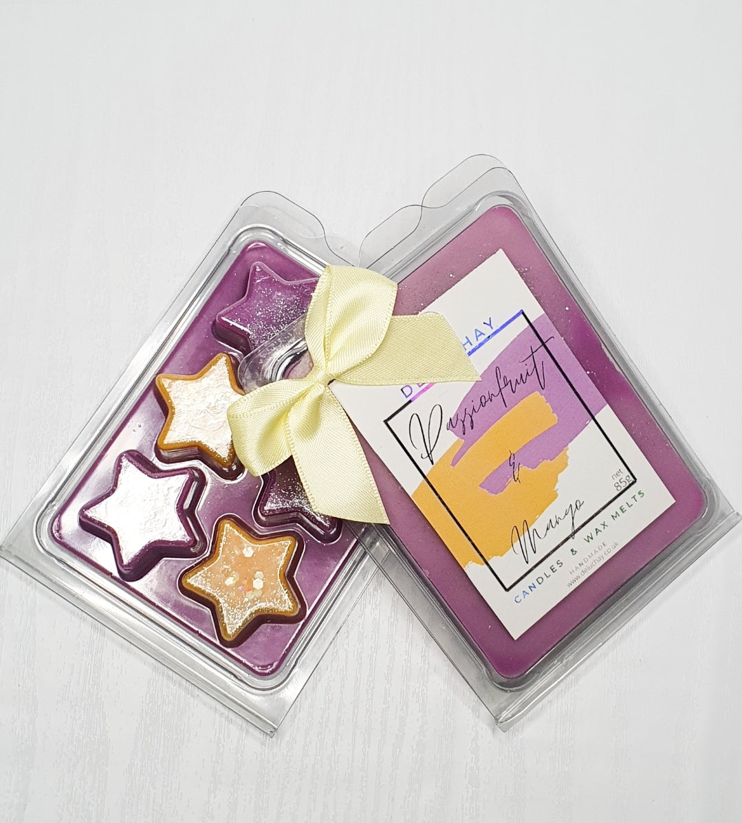 Strawberry and Mango wax melts in star, heart, and cube shapes, showcasing vibrant colors and delightful fragrances.