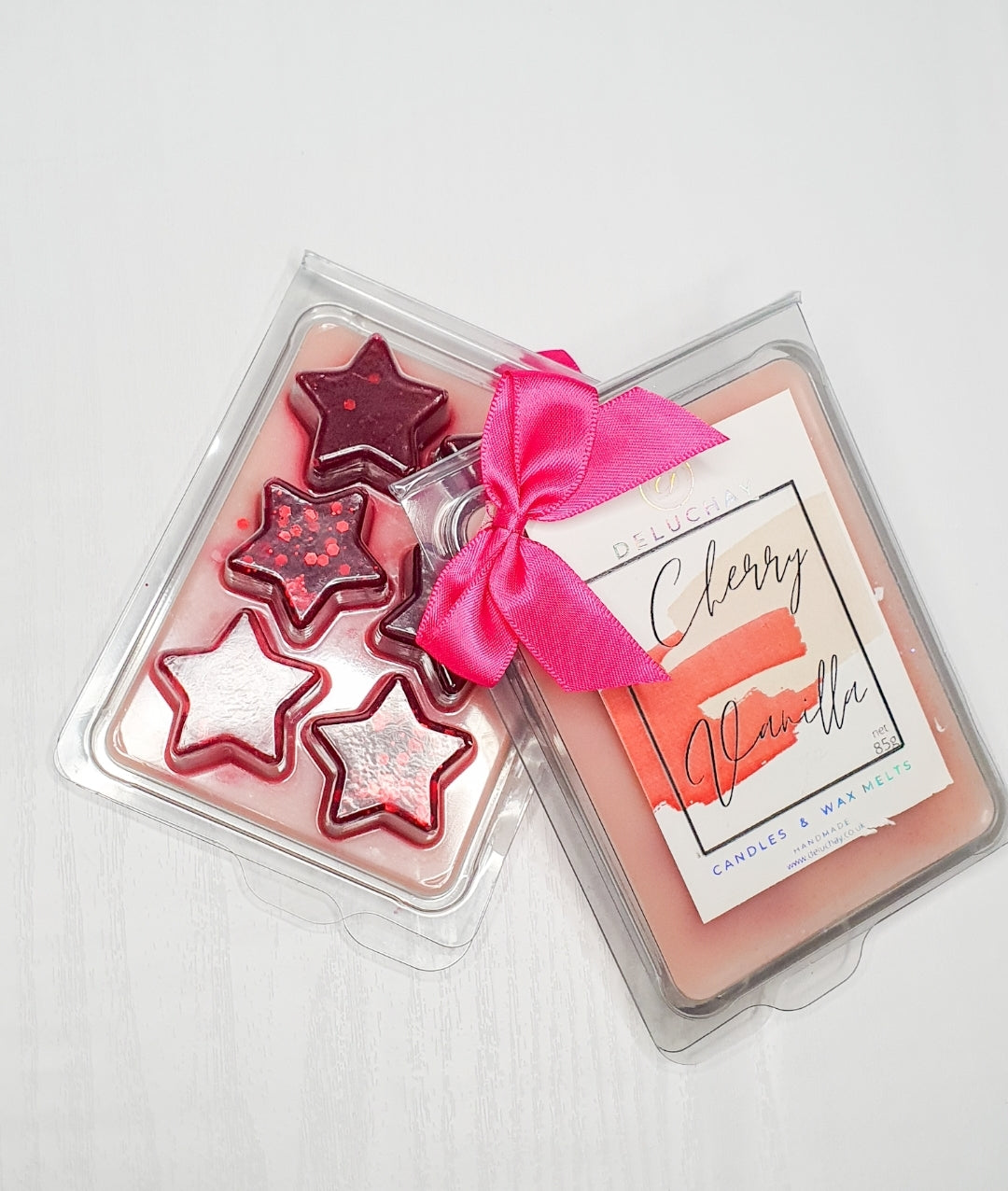 Strawberry and Mango wax melts in star, heart, and cube shapes, showcasing vibrant colors and delightful fragrances.