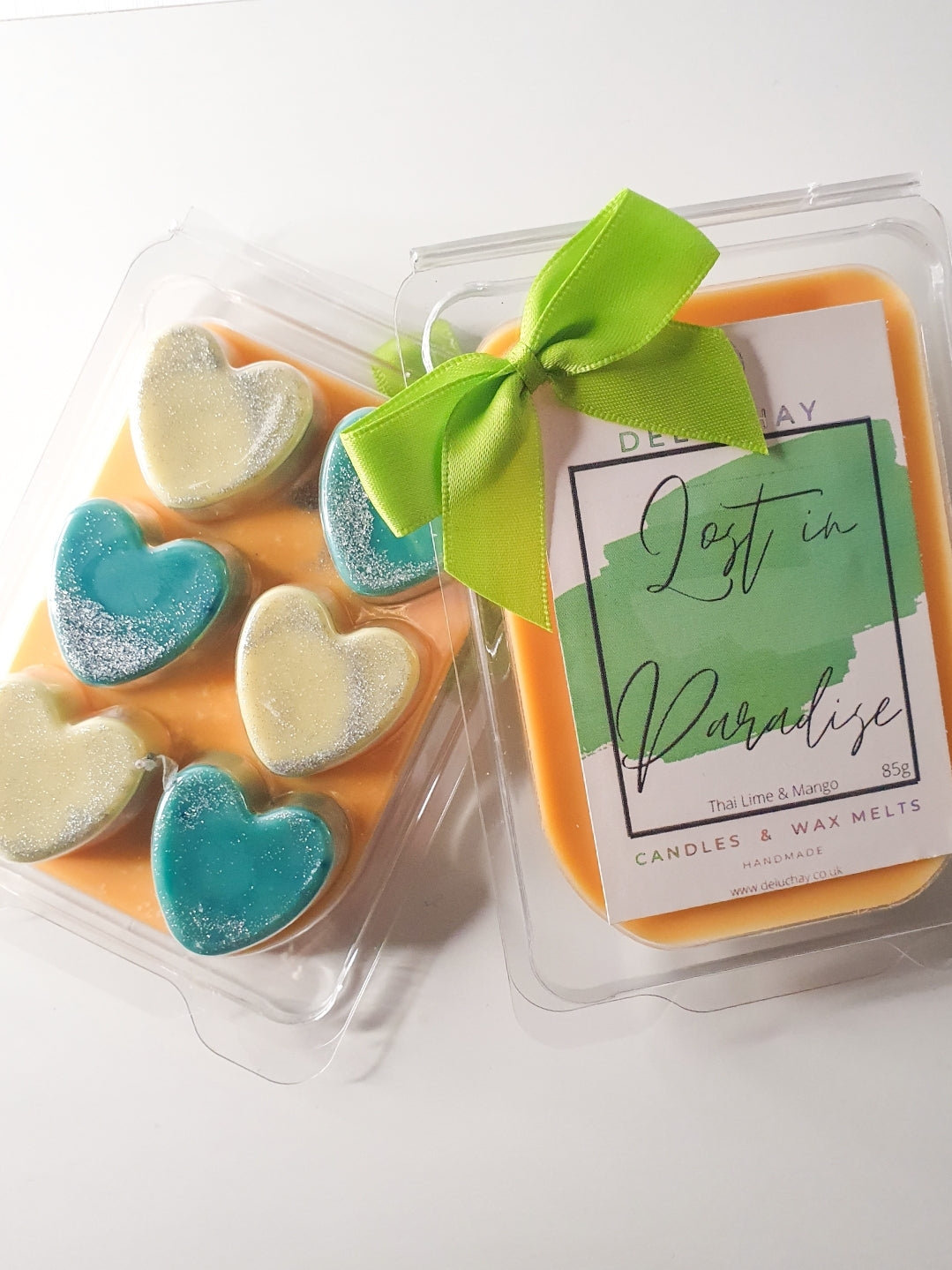 Strawberry and Mango wax melts in star, heart, and cube shapes, showcasing vibrant colors and delightful fragrances.