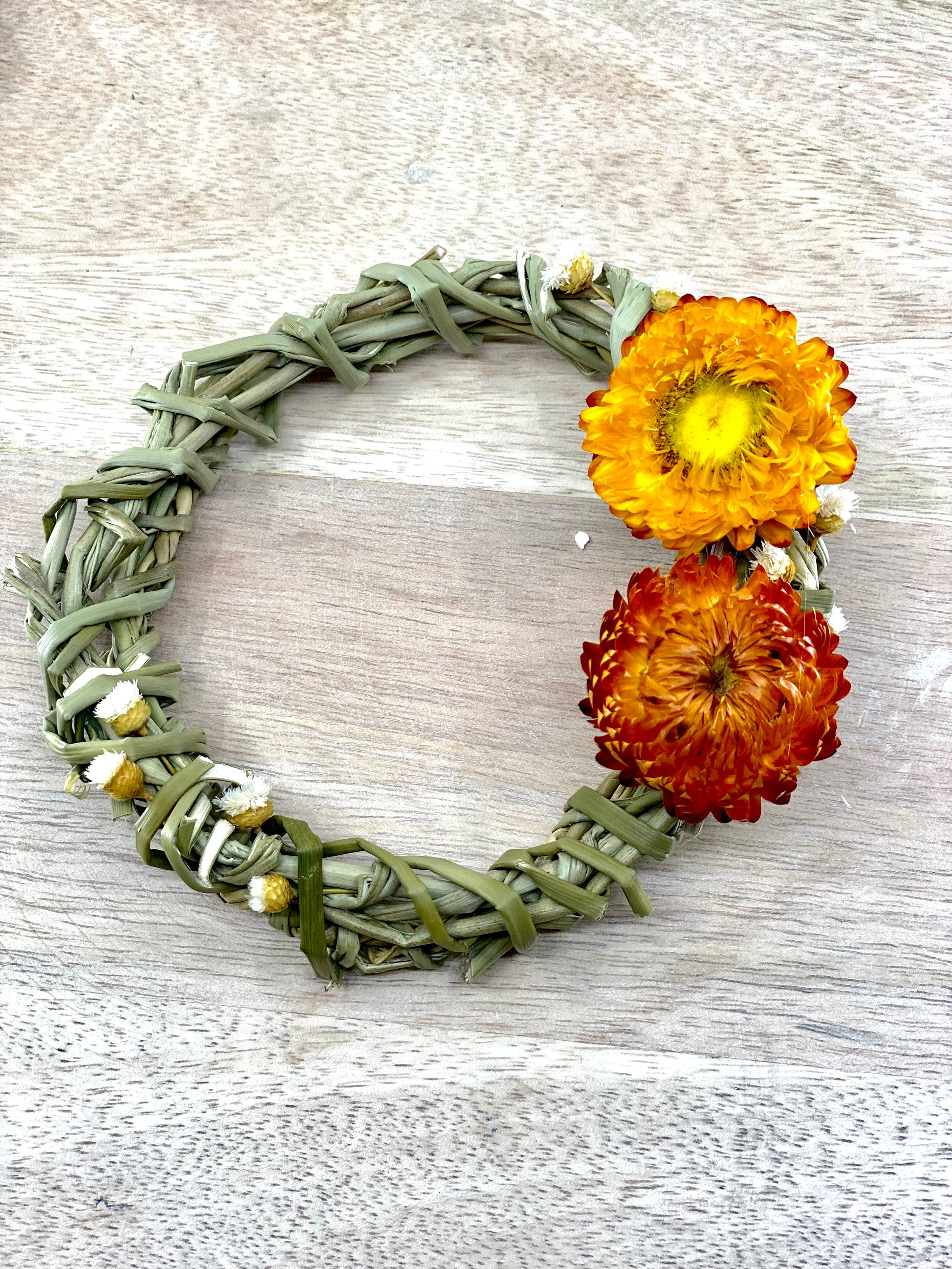 A 4-inch Summer Harvest Sweetgrass Wreath Ornament made with dried flowers, showcasing its delicate and lightweight design.