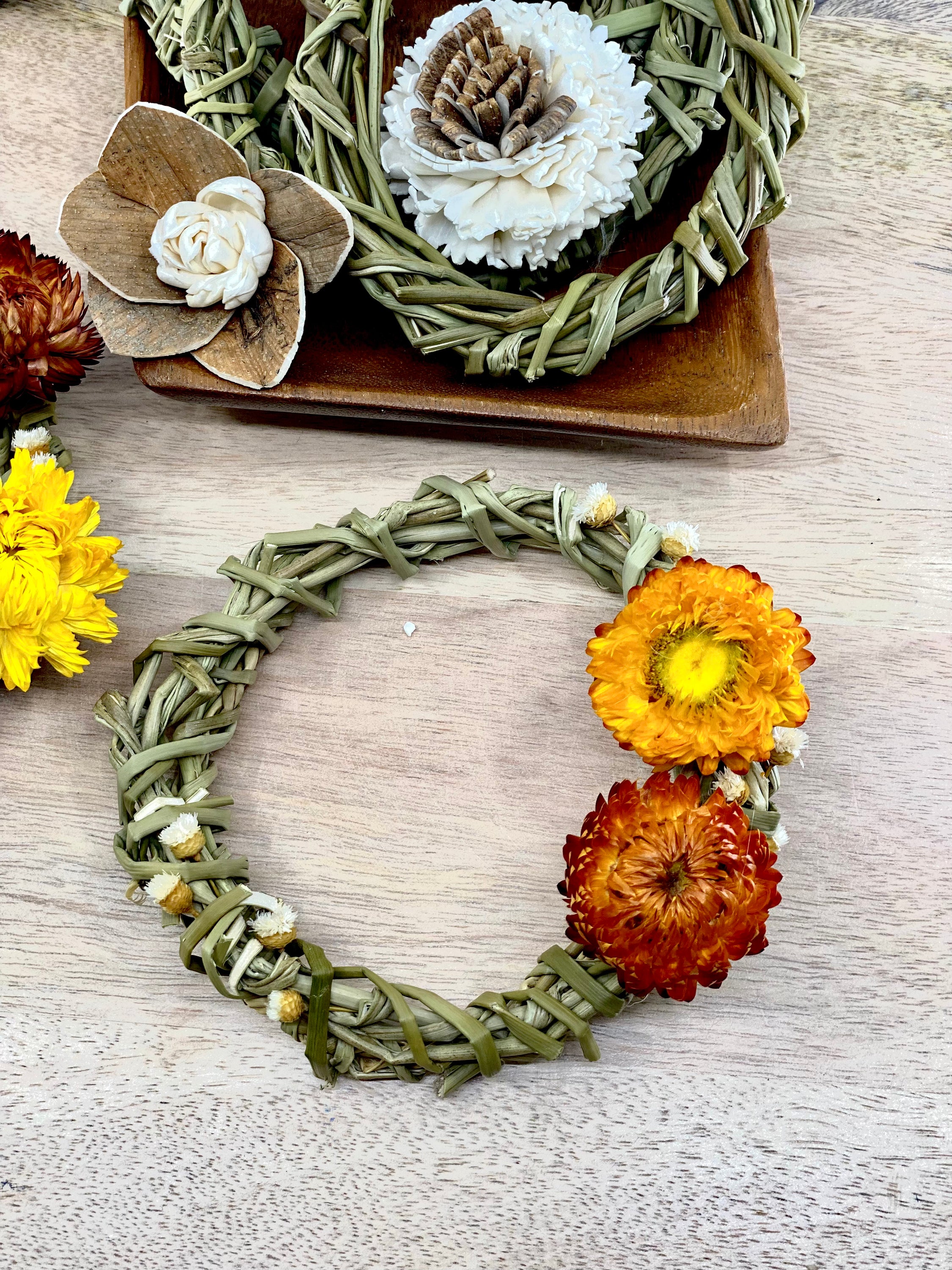 A 4-inch Summer Harvest Sweetgrass Wreath Ornament made with dried flowers, showcasing its delicate and lightweight design.