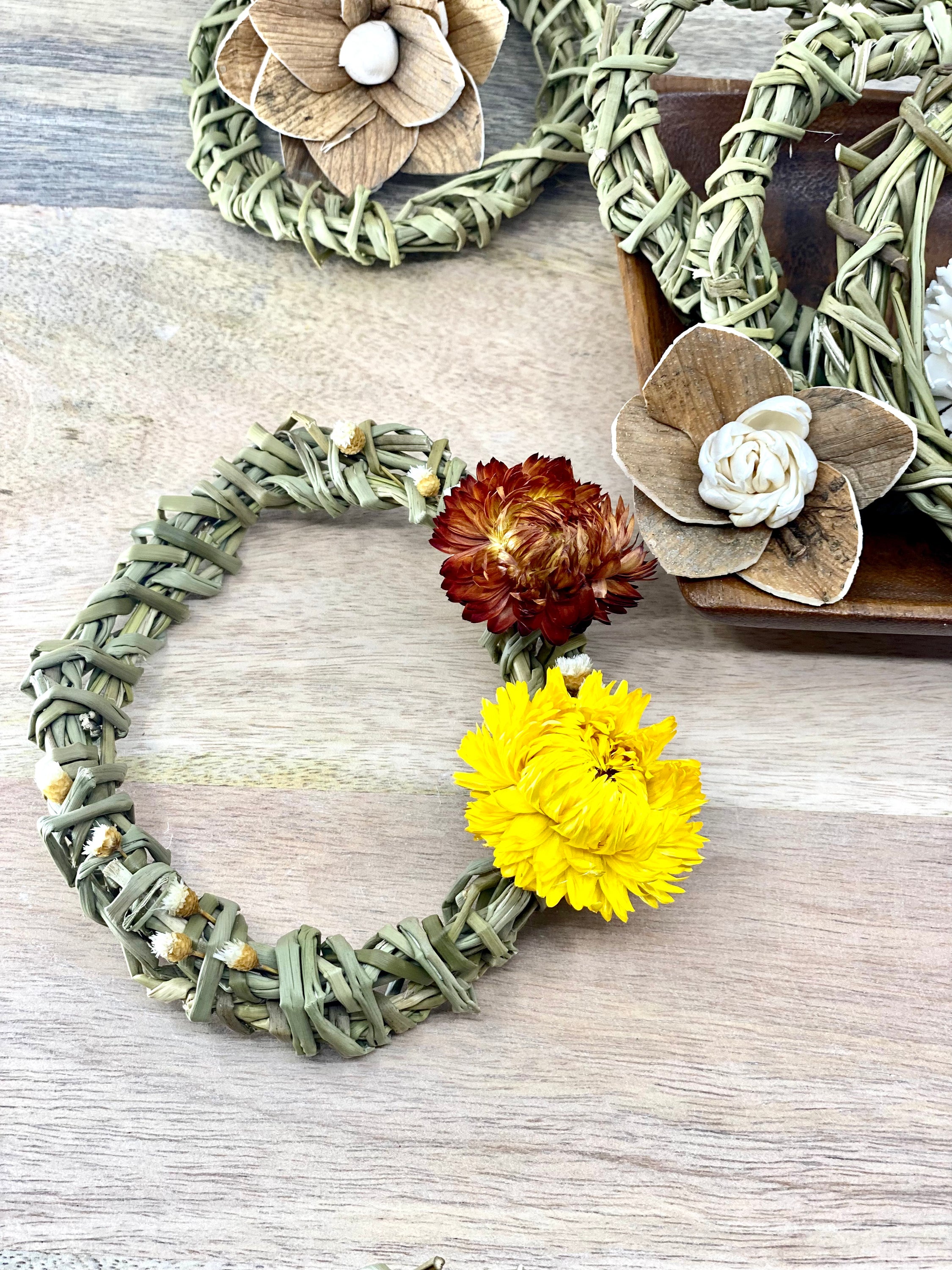 A 4-inch Summer Harvest Sweetgrass Wreath Ornament made with dried flowers, showcasing its delicate and lightweight design.