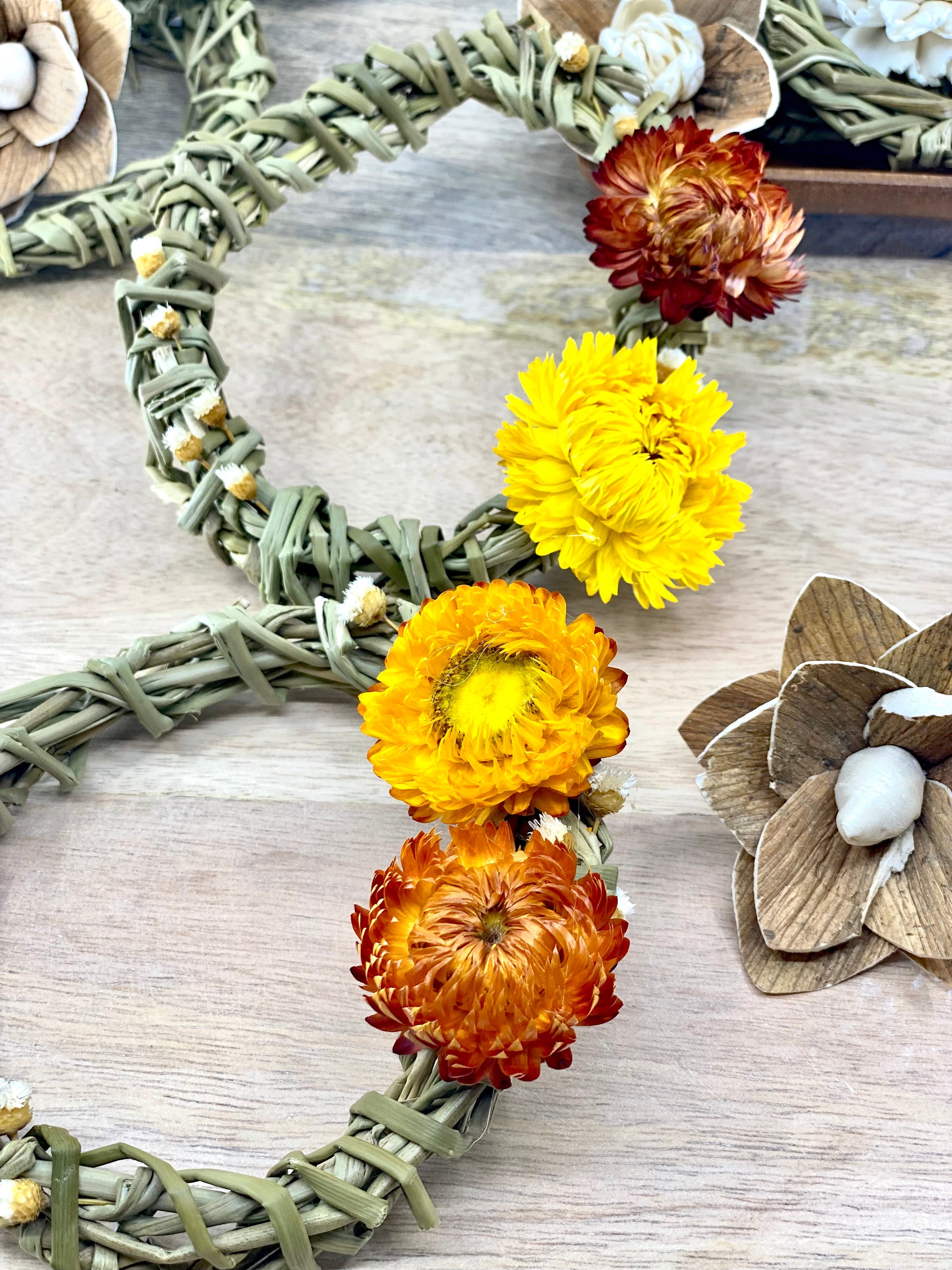 A 4-inch Summer Harvest Sweetgrass Wreath Ornament made with dried flowers, showcasing its delicate and lightweight design.