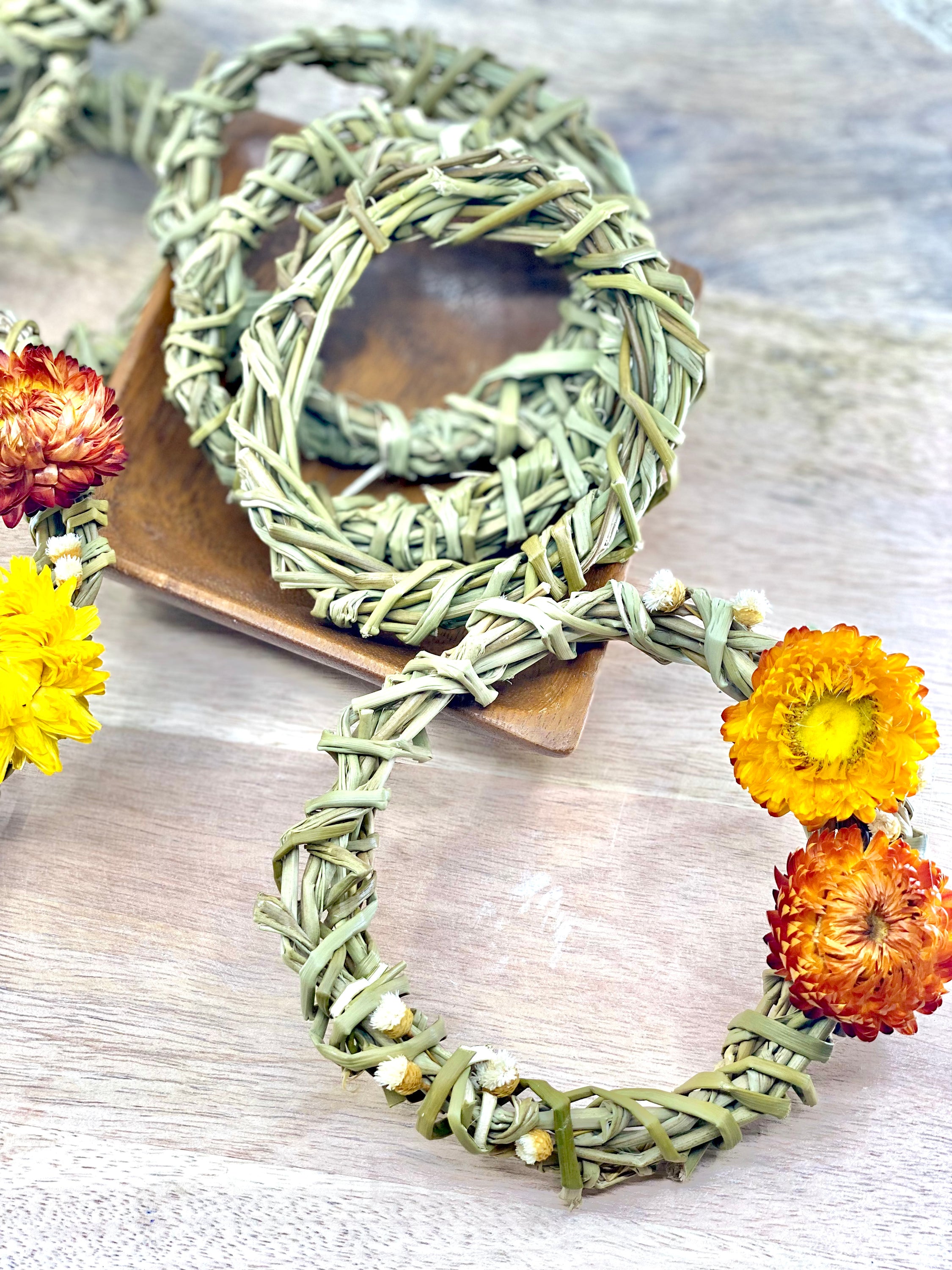 A 4-inch Summer Harvest Sweetgrass Wreath Ornament made with dried flowers, showcasing its delicate and lightweight design.