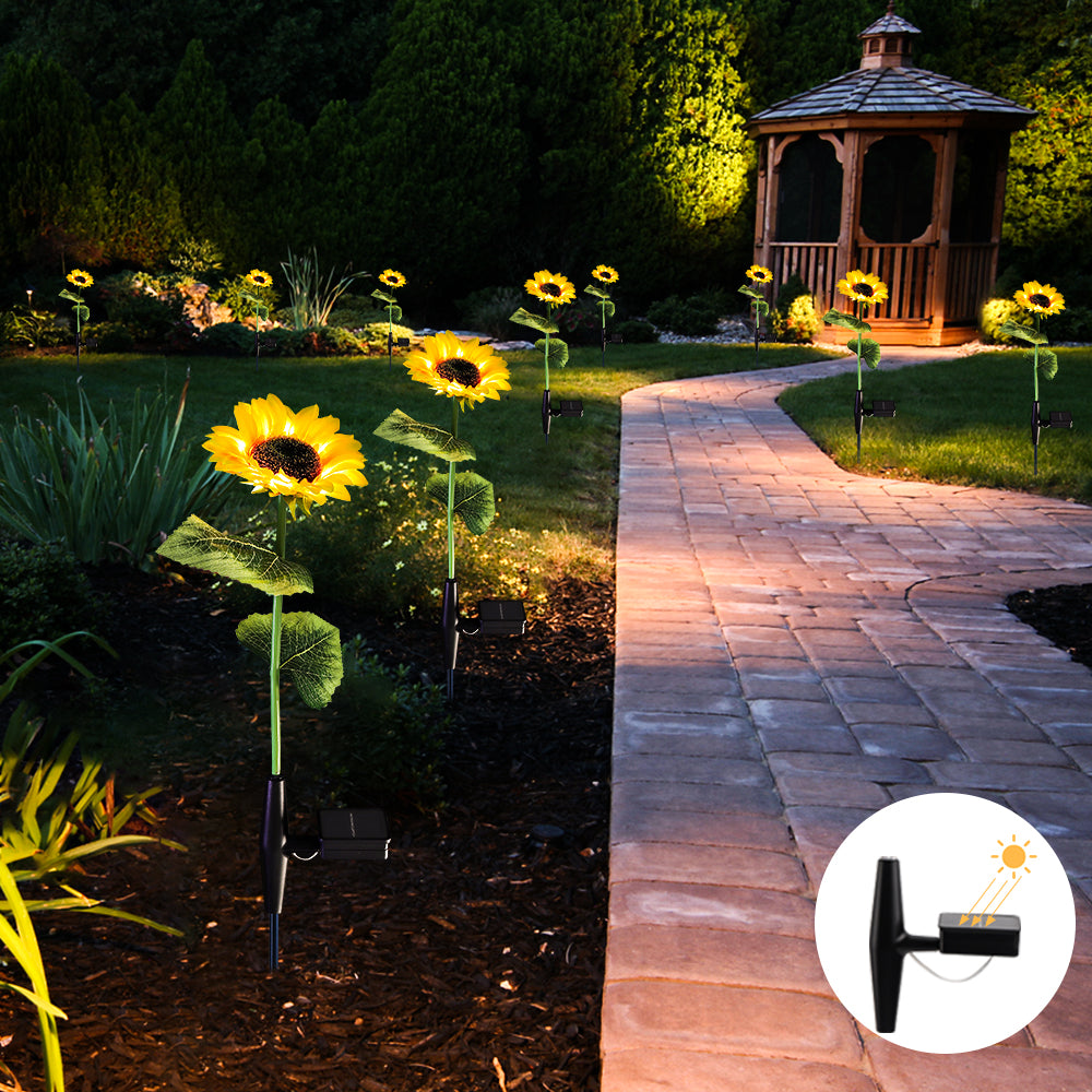 Two solar sunflower lights glowing in a garden setting, showcasing their vibrant colors and lifelike design.