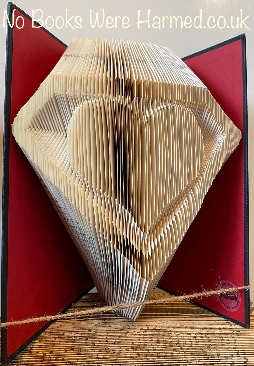 A handcrafted Superb Heart art piece made from folded pages of vintage books, showcasing intricate details and unique design.