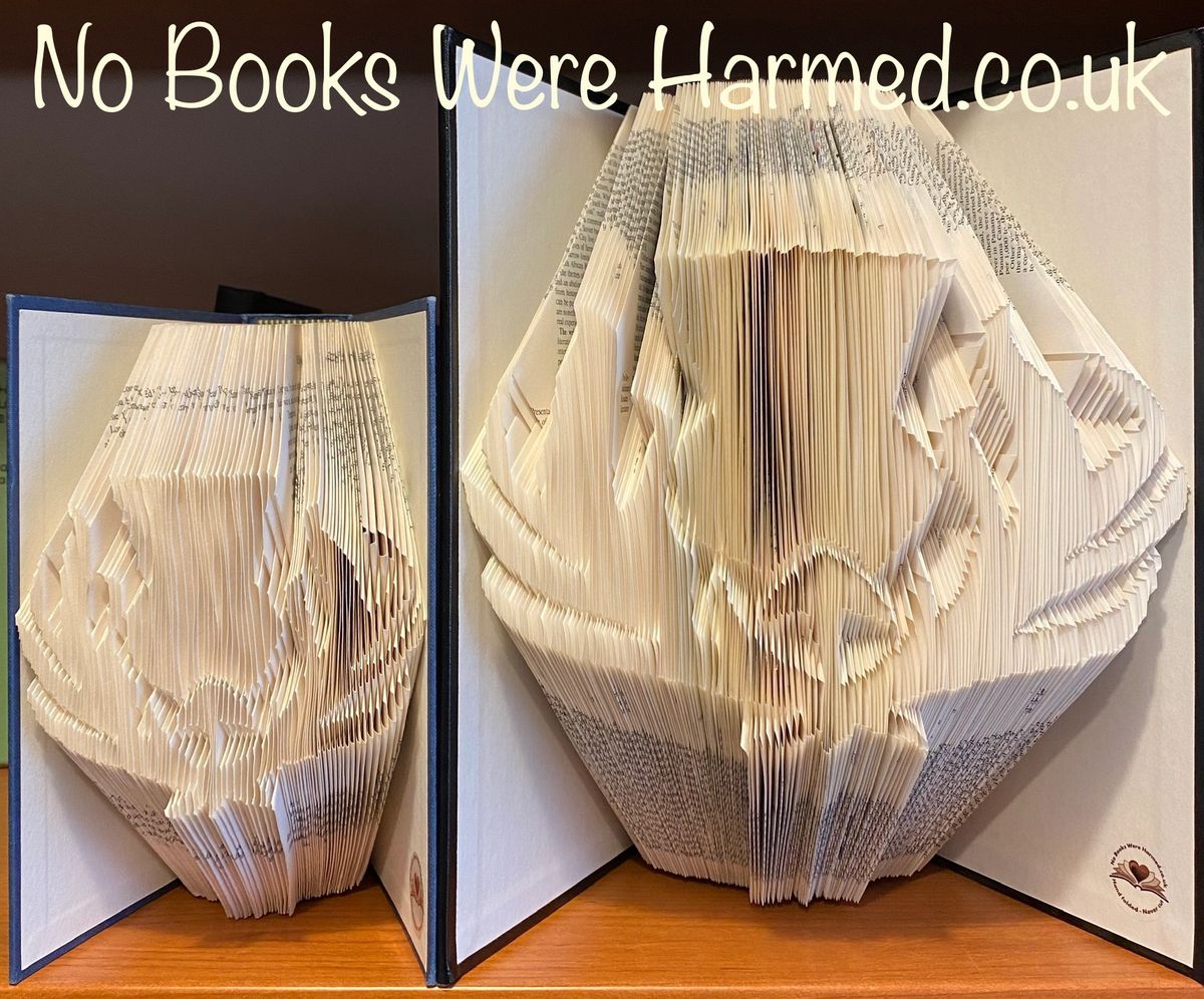 Hand-folded book art featuring a Scottish thistle design, crafted from vintage Encyclopedia pages with a classic black padded cover.