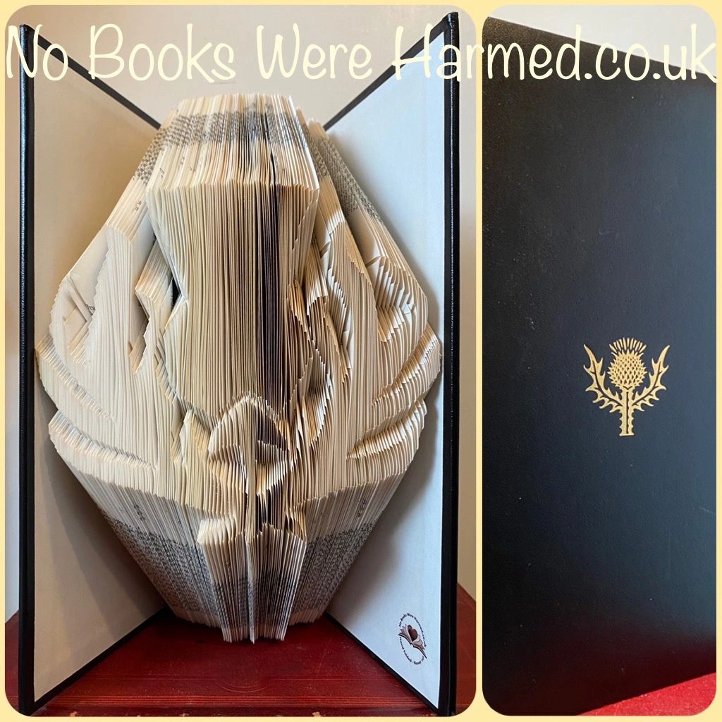 Hand-folded book art featuring a Scottish thistle design, crafted from vintage Encyclopedia pages with a classic black padded cover.