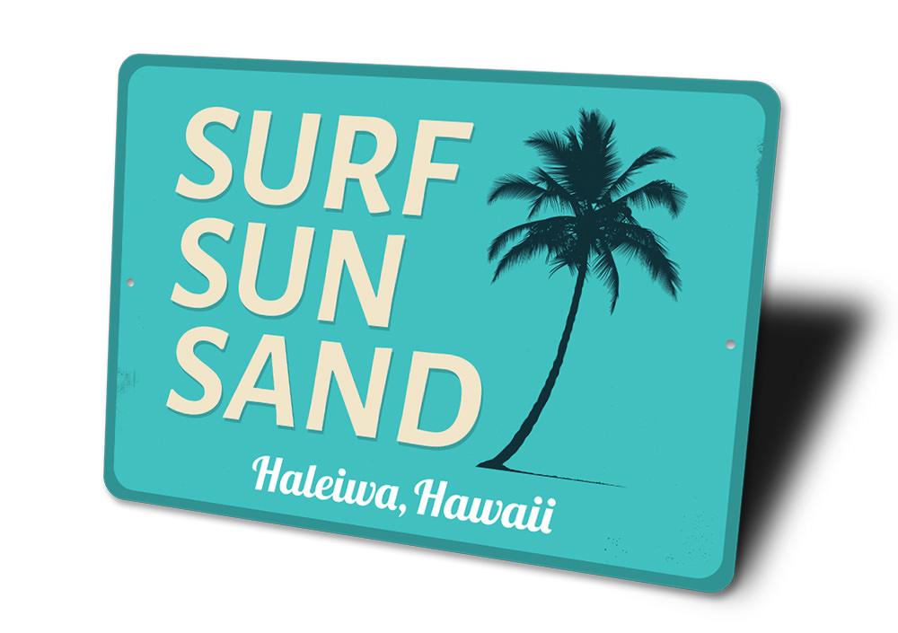 A decorative Surf Sun Sand Sign made of aluminum, featuring vibrant colors and a beach-themed design, perfect for coastal decor.