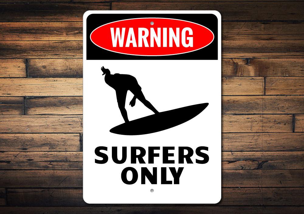 Surfers Only decorative sign made of high-quality aluminum, featuring a beach-themed design perfect for surf enthusiasts.