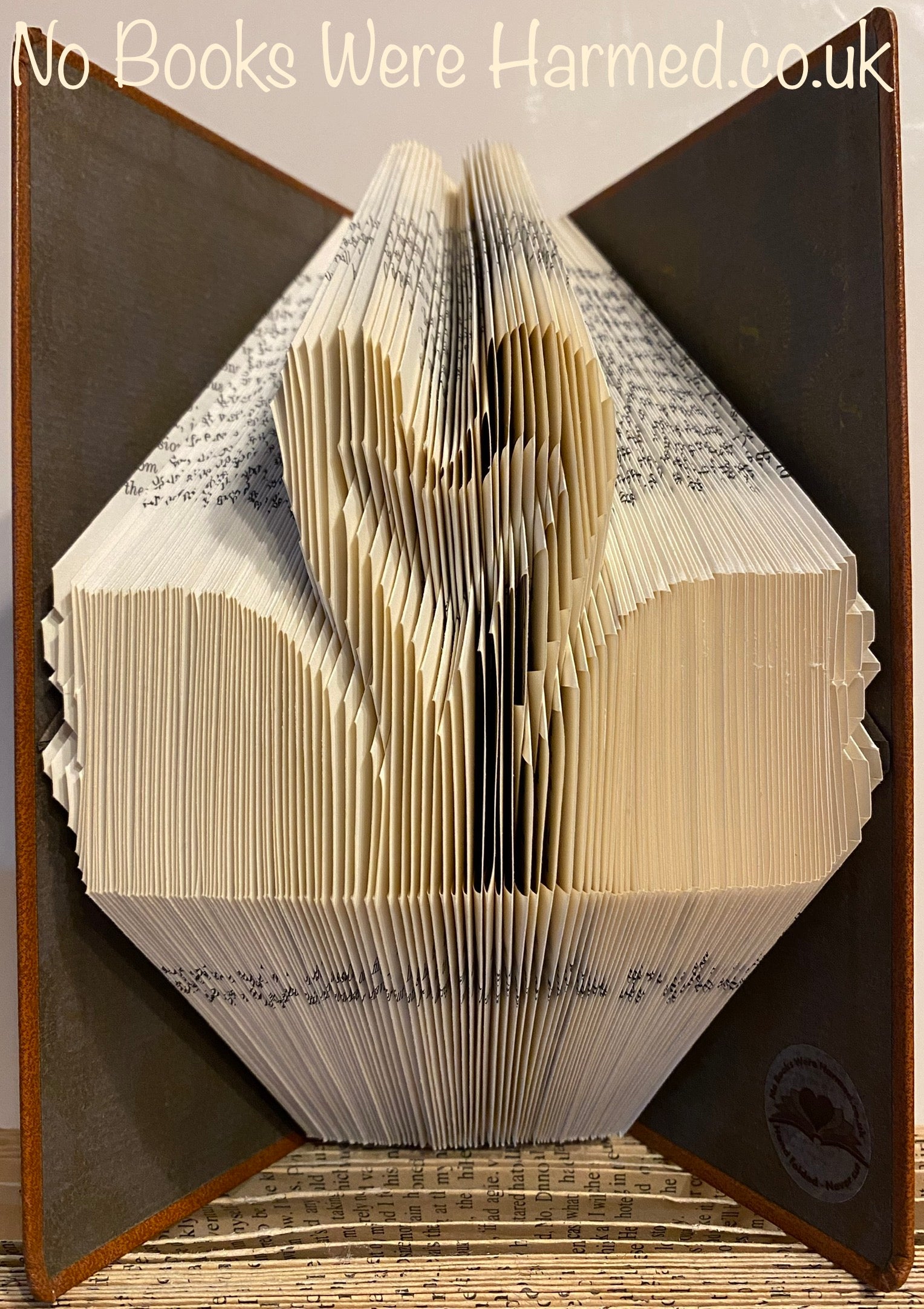 Handcrafted Swans In Love art piece made from vintage book pages, showcasing intricate folds and unique design.