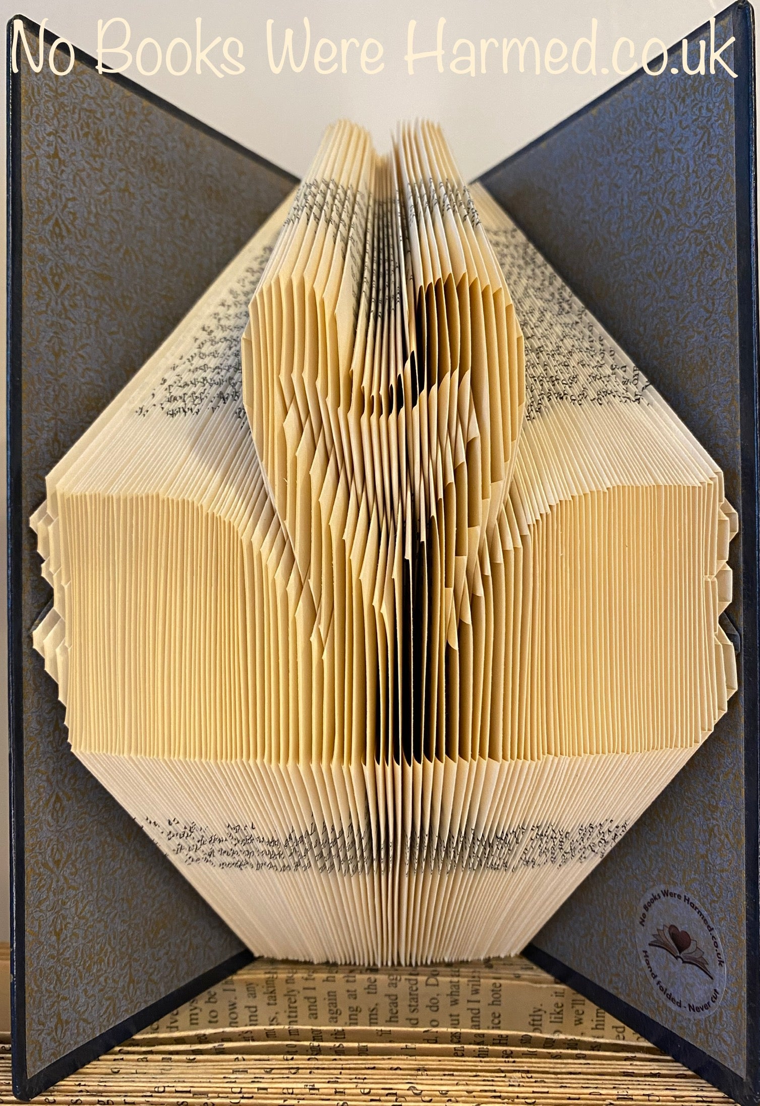 Handcrafted Swans In Love art piece made from vintage book pages, showcasing intricate folds and unique design.