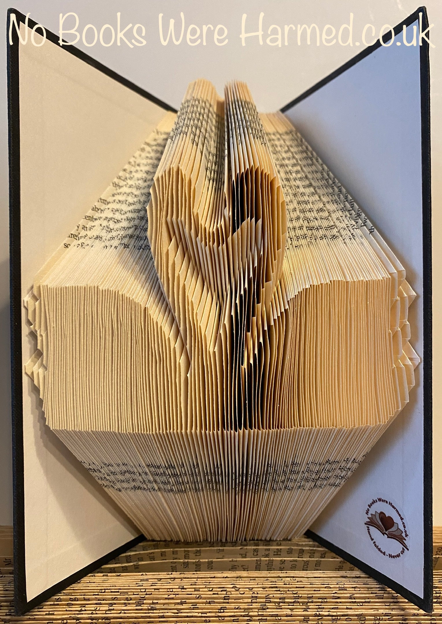 Handcrafted Swans In Love art piece made from vintage book pages, showcasing intricate folds and unique design.