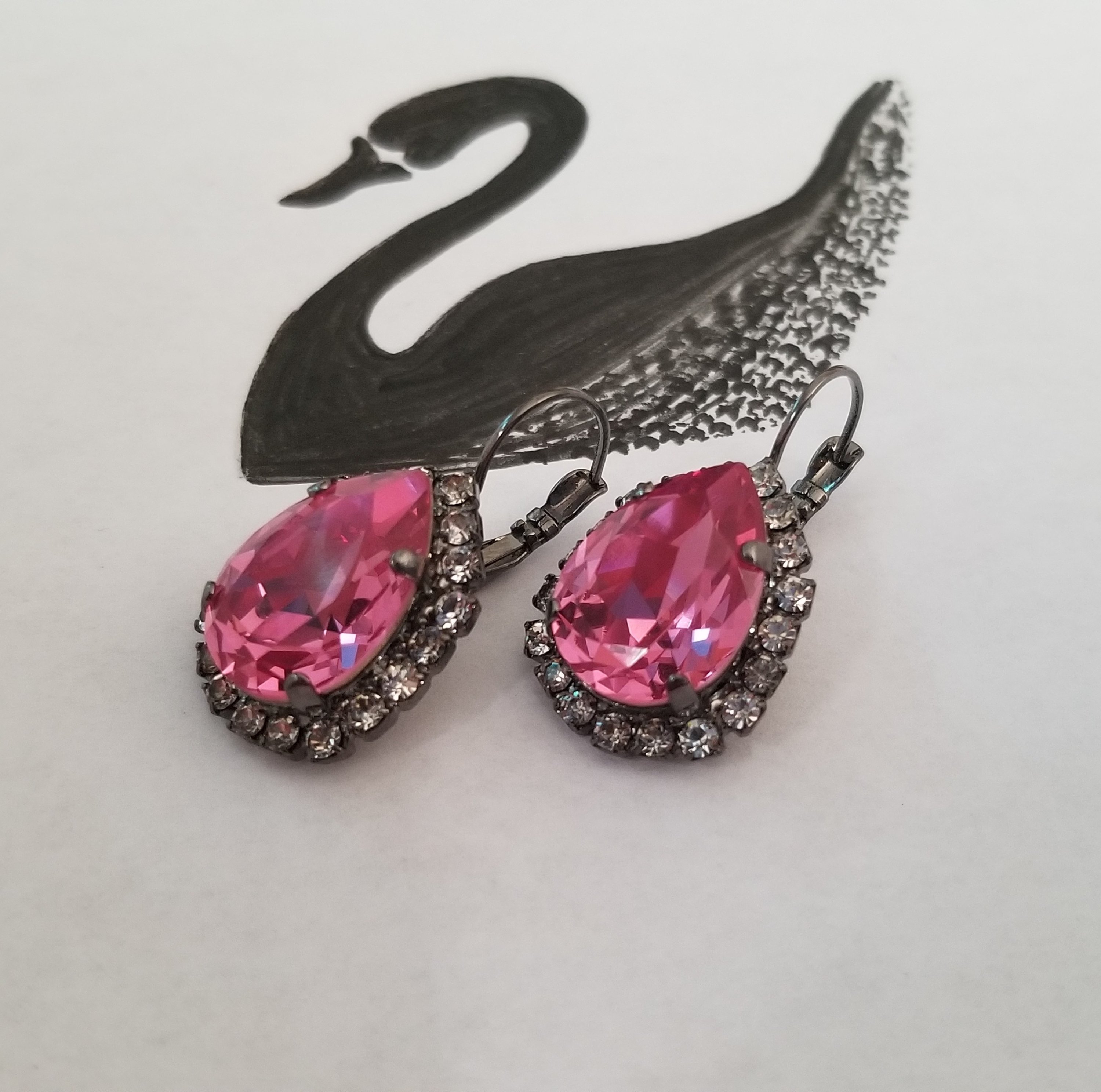 Elegant Swarovski Crystal Pear Shaped Statement Earrings featuring vibrant colored crystals in gold, silver, and hematite settings.