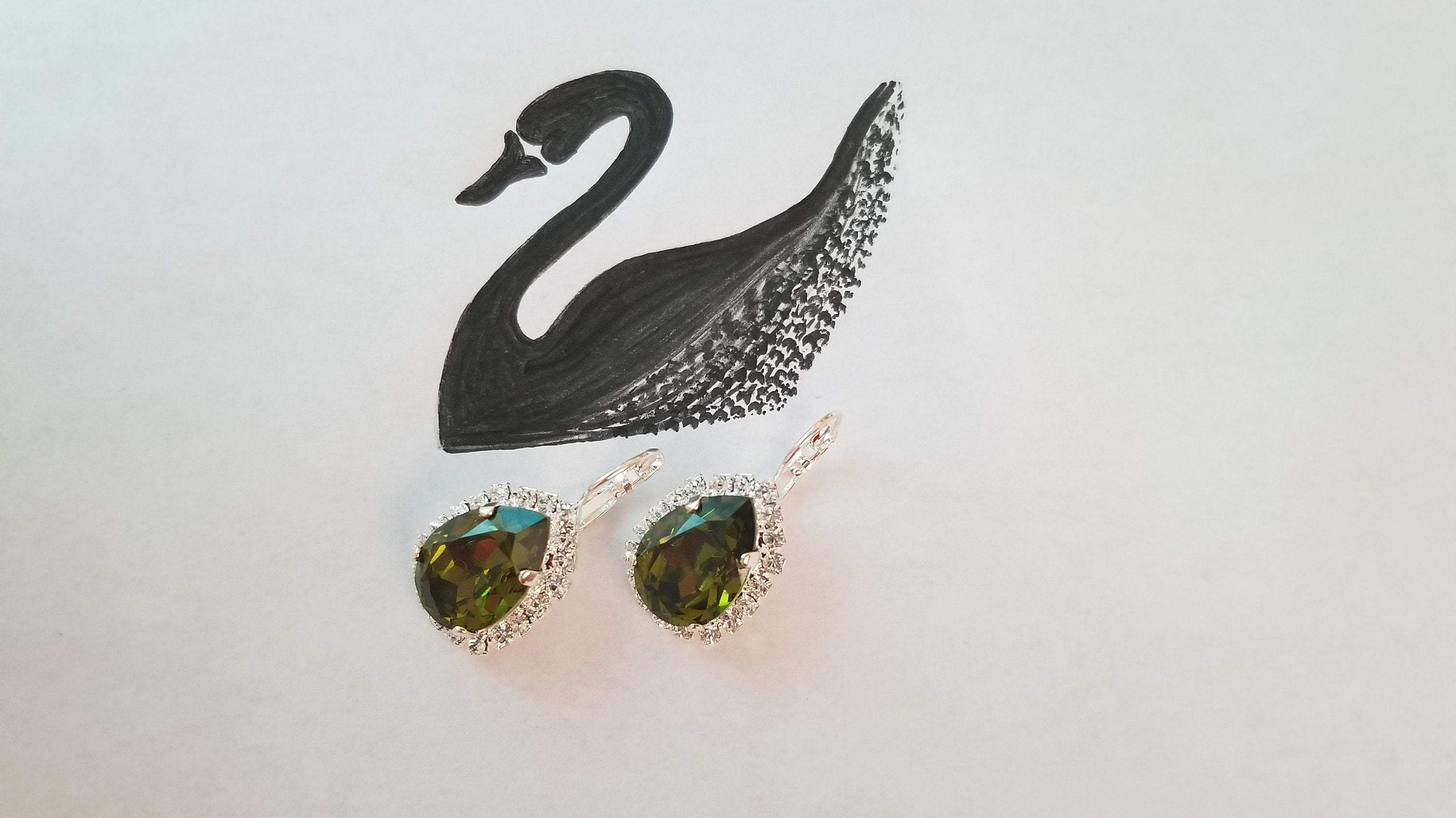 Elegant Swarovski Crystal Pear Shaped Statement Earrings featuring vibrant colored crystals in gold, silver, and hematite settings.