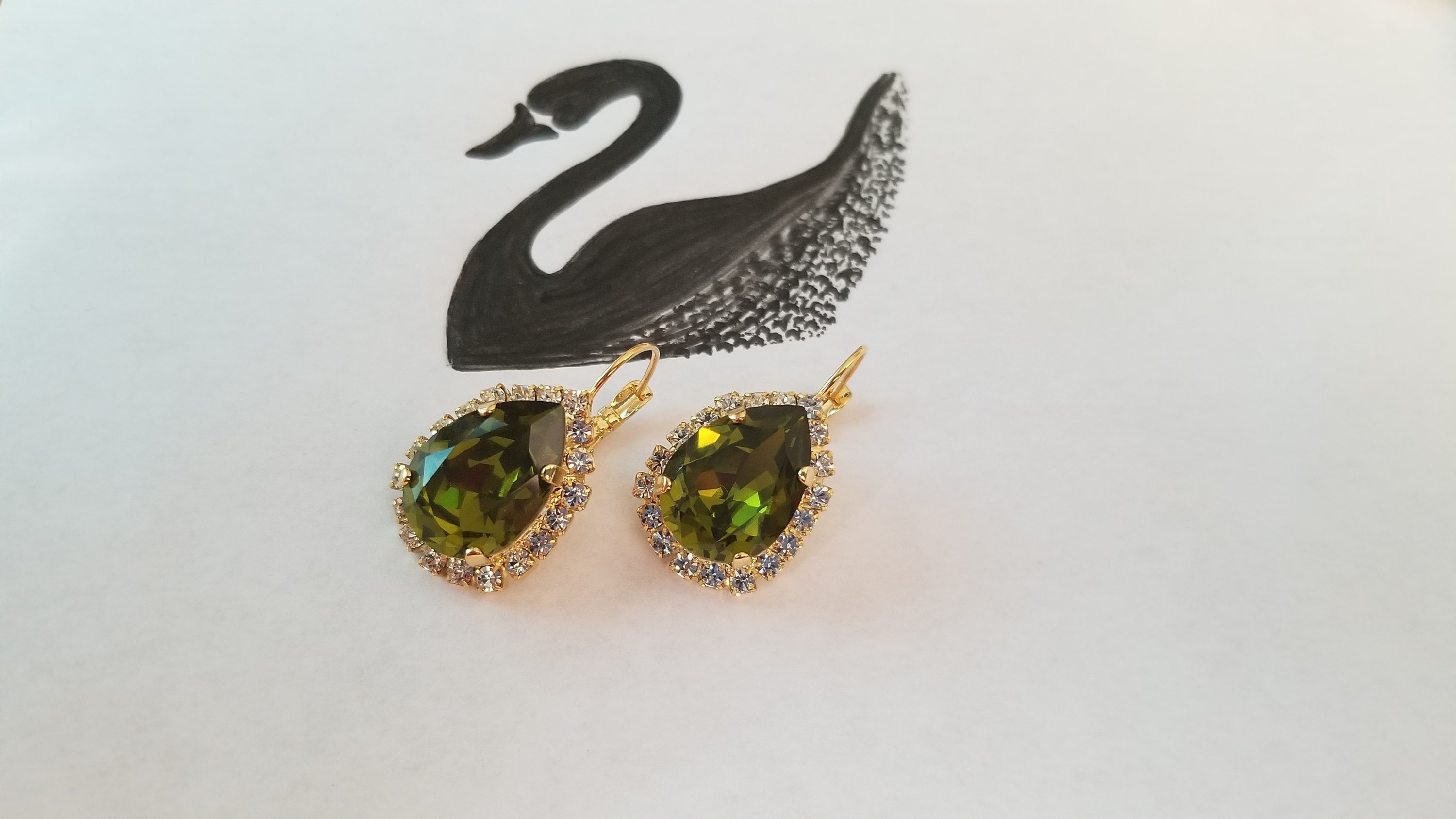 Elegant Swarovski Crystal Pear Shaped Statement Earrings featuring vibrant colored crystals in gold, silver, and hematite settings.