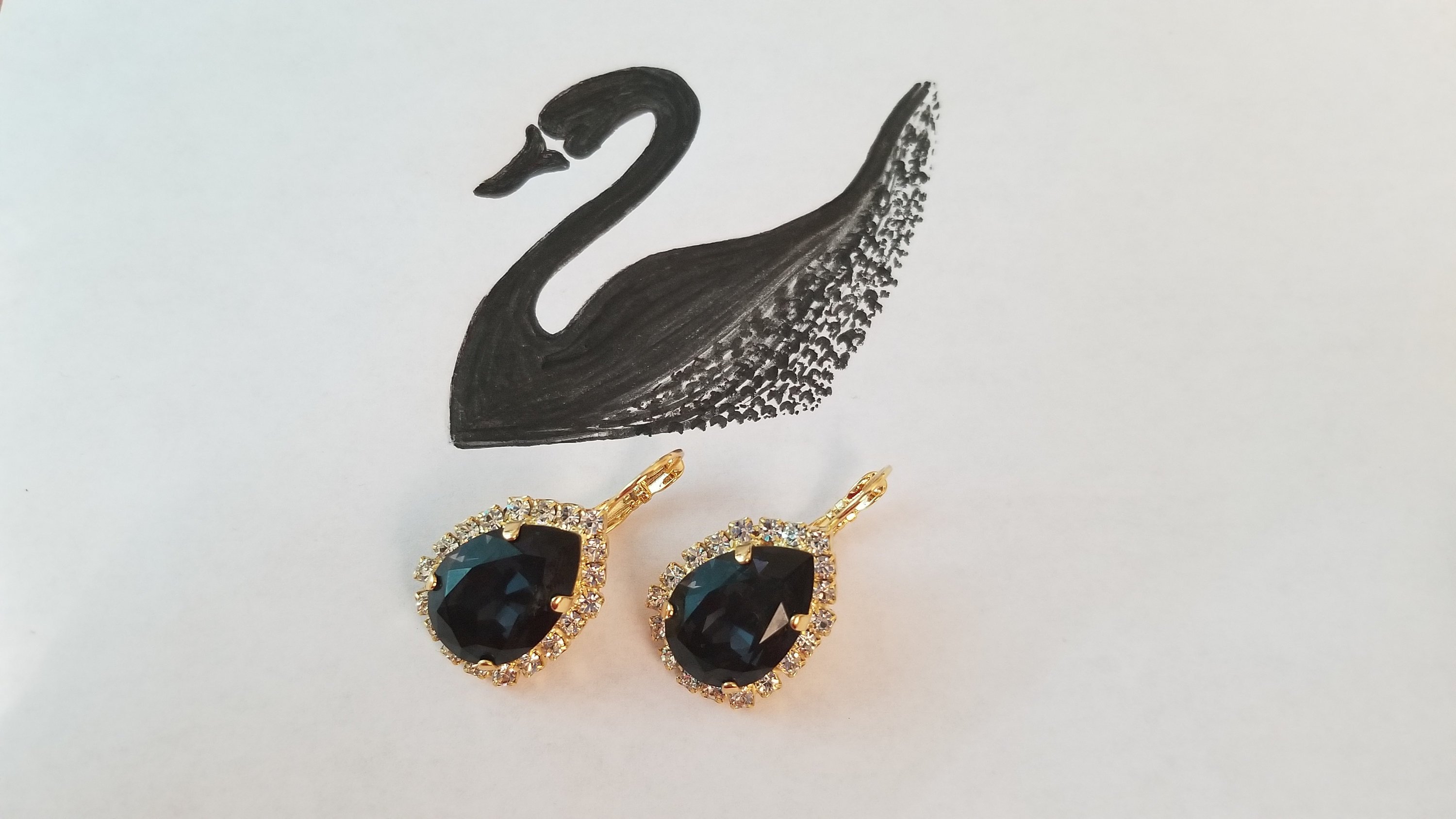 Elegant Swarovski Crystal Pear Shaped Statement Earrings featuring vibrant colored crystals in gold, silver, and hematite settings.