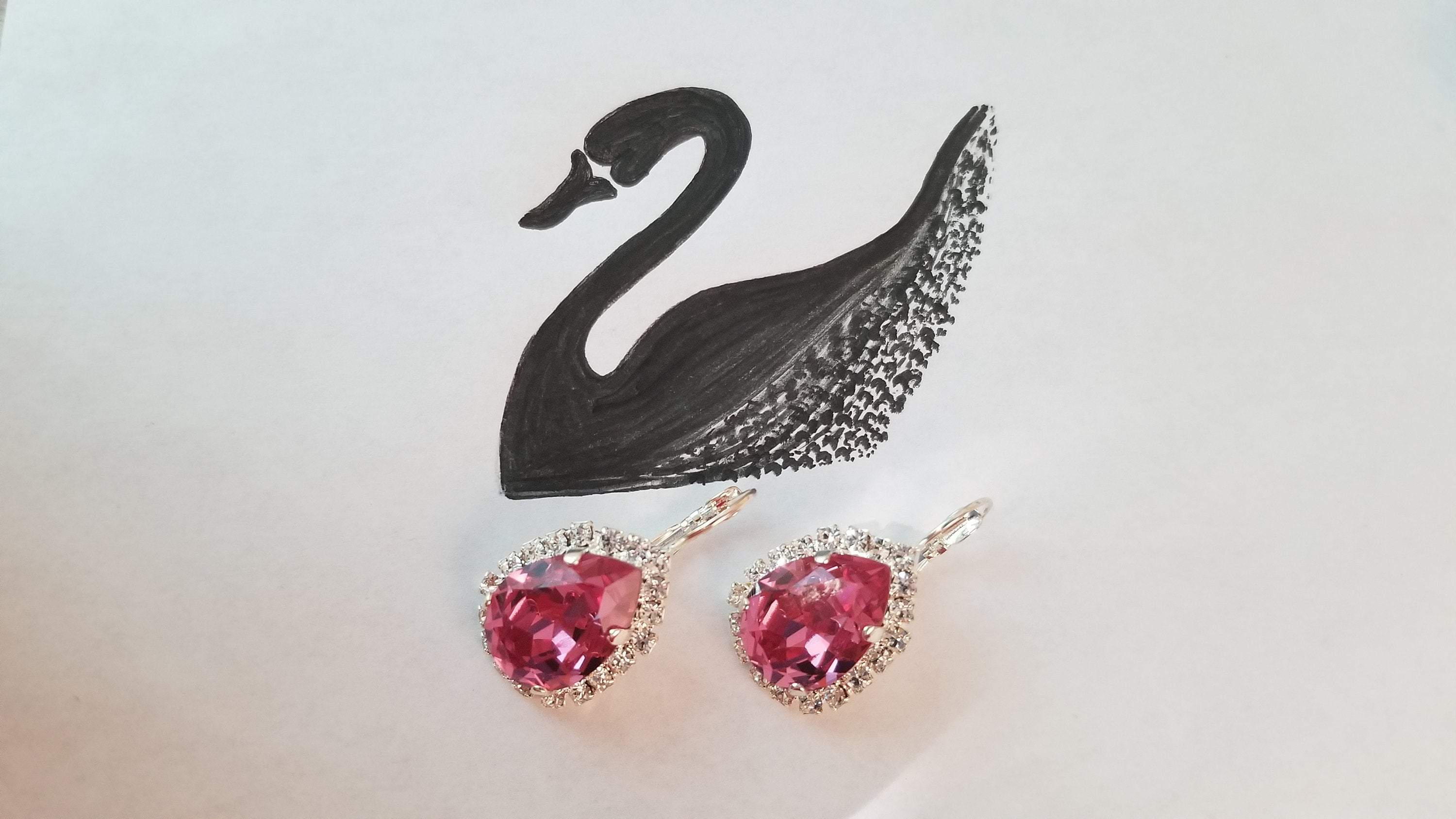 Elegant Swarovski Crystal Pear Shaped Statement Earrings featuring vibrant colored crystals in gold, silver, and hematite settings.