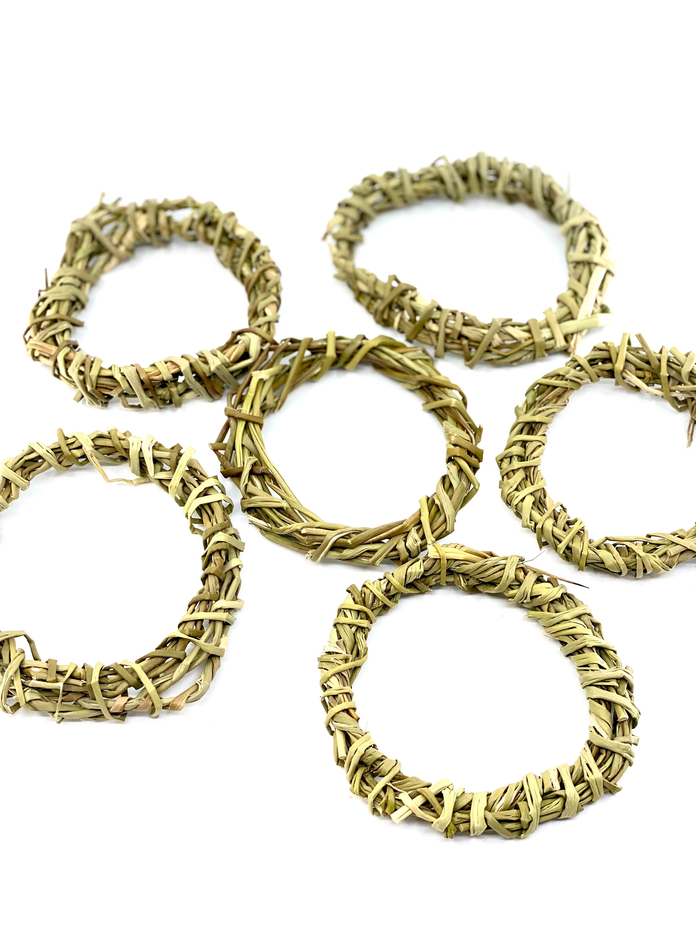 A pack of six 4-inch handmade sweetgrass wreath forms, showcasing their natural texture and delicate design, perfect for crafting and indoor decor.