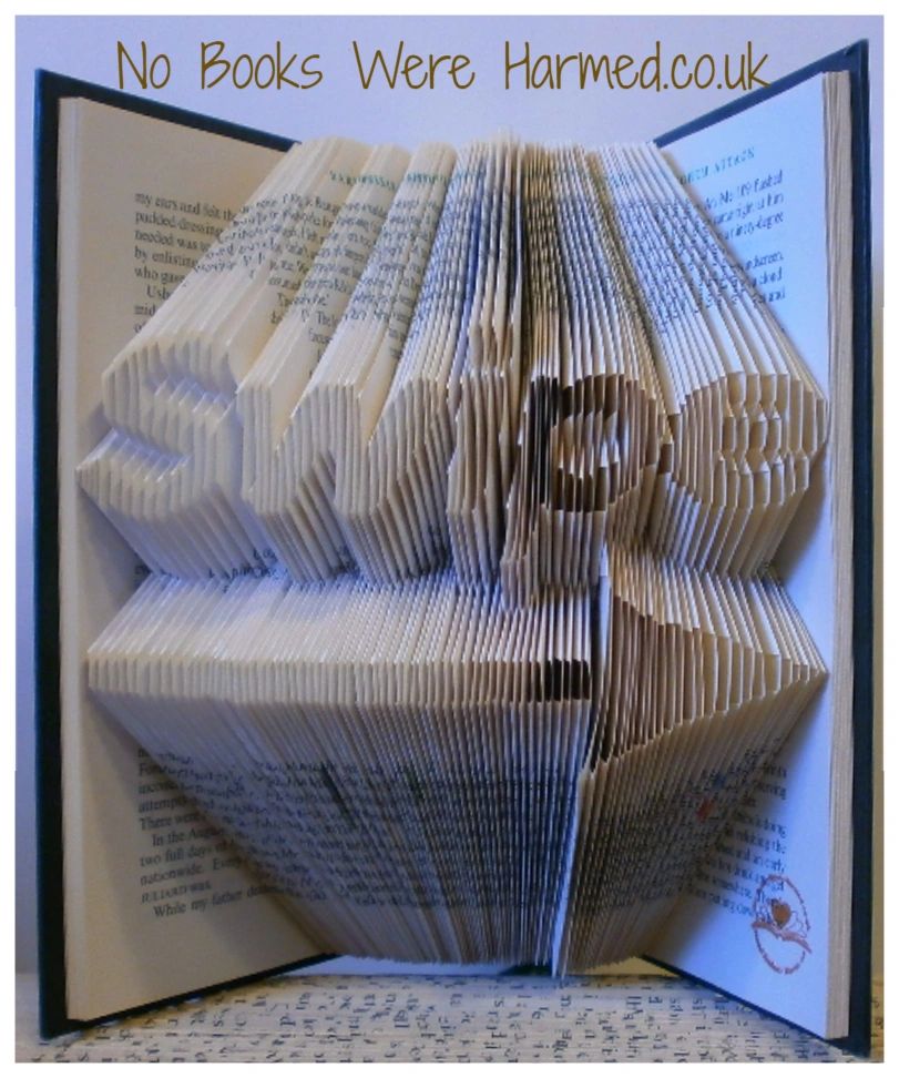 A beautifully crafted piece of hand-folded book art made from vintage books, showcasing intricate designs and unique textures.