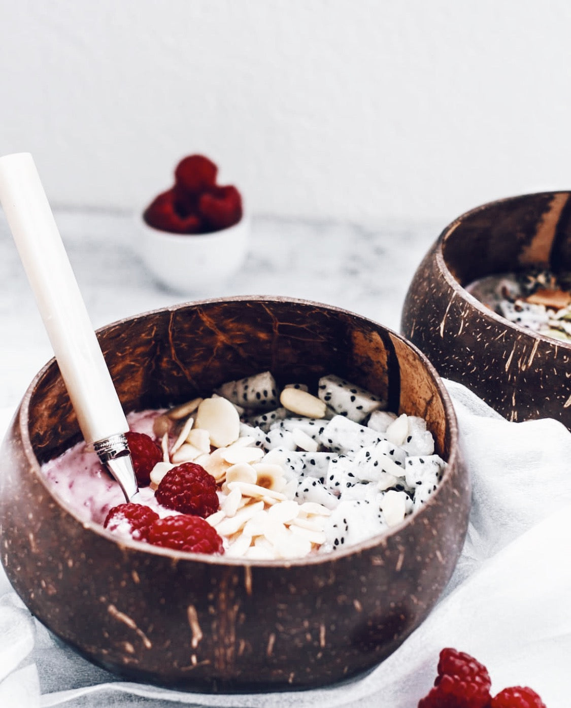 A beautifully crafted Taça de Coco Natural bowl made from real coconut shell, showcasing its unique texture and shape.