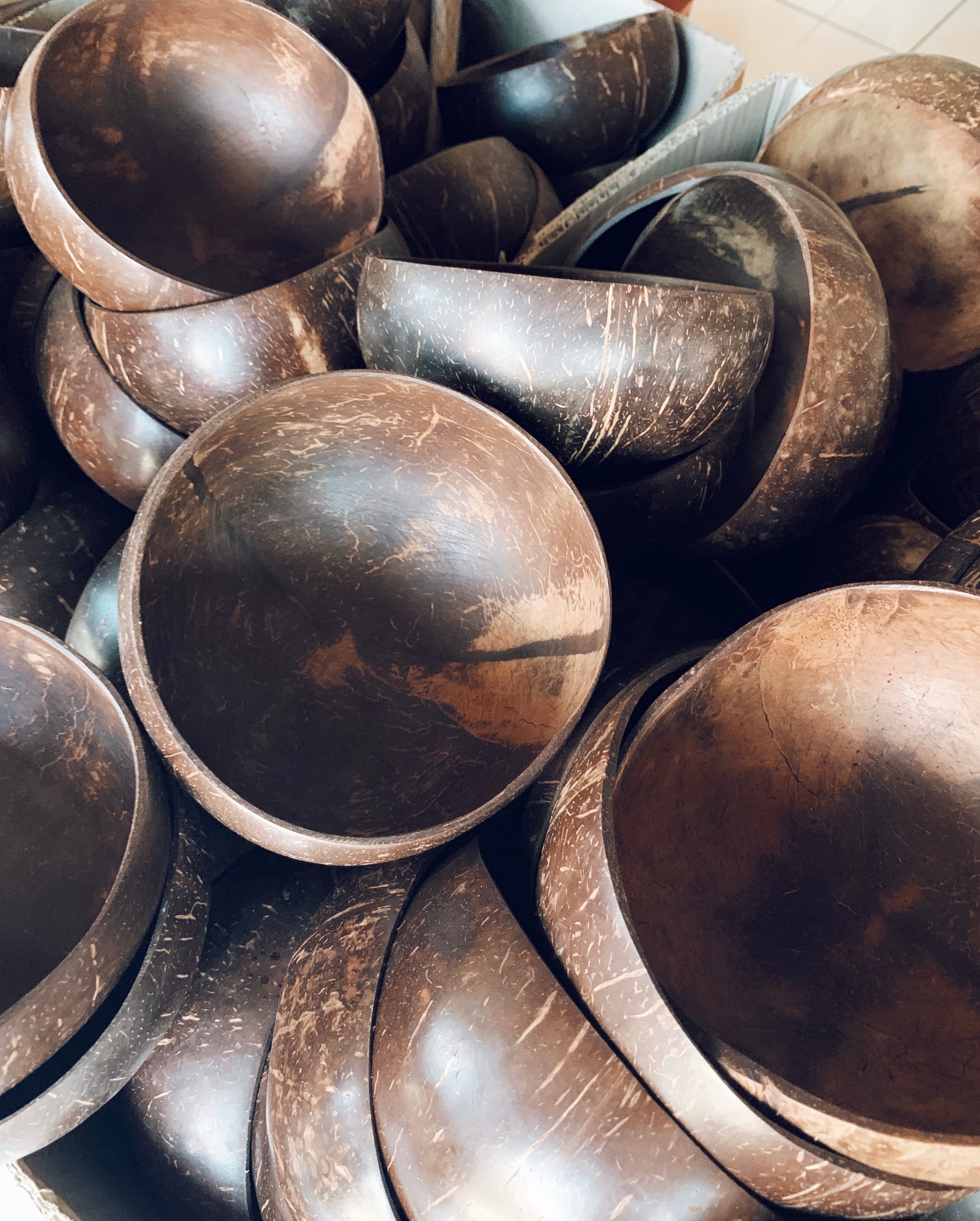 A beautifully crafted Taça de Coco Natural bowl made from real coconut shell, showcasing its unique texture and shape.