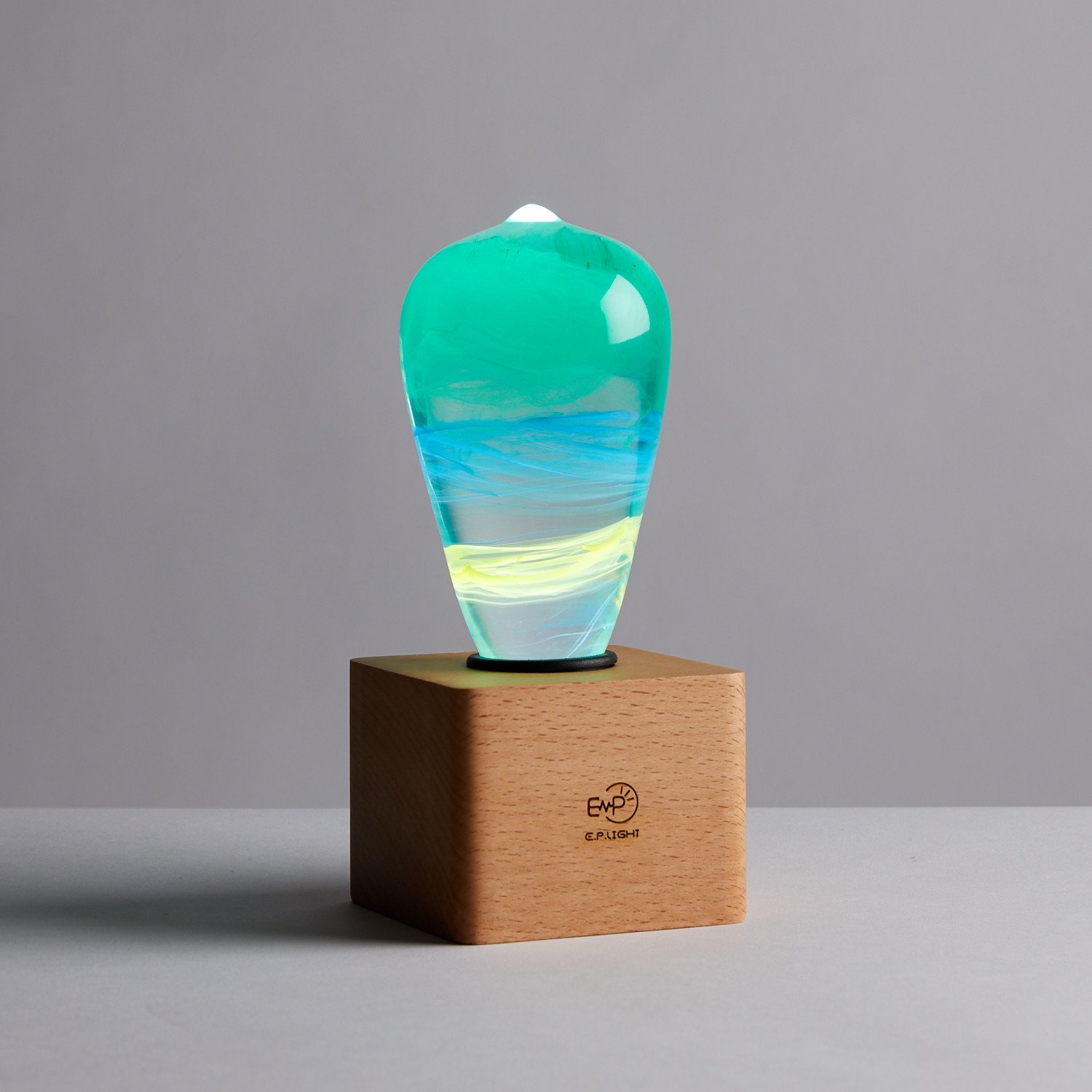 Alice Table Lamp featuring eco-friendly resin and beech wood, available in mixed colors, with an LED bulb.