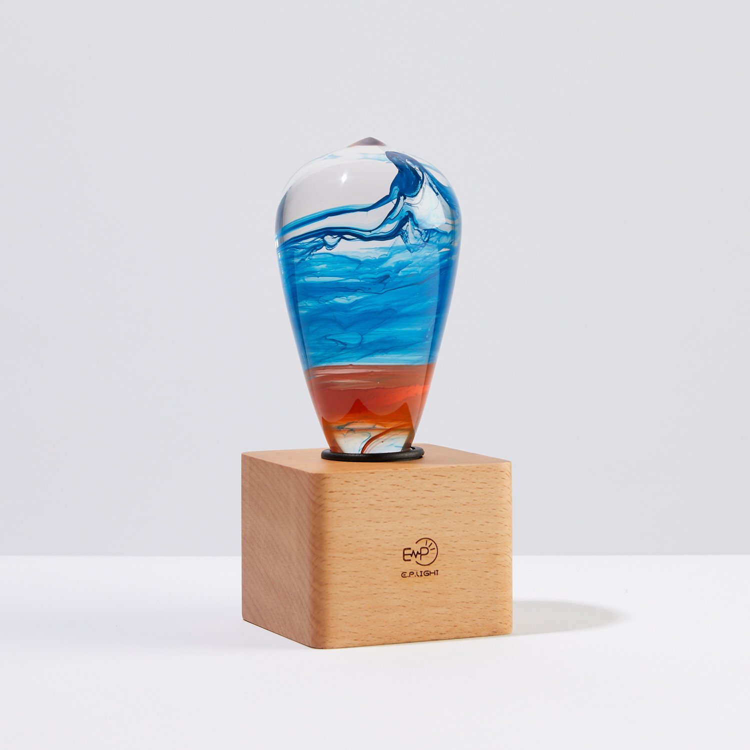 A beautifully handcrafted Fire Table Lamp made of eco-friendly resin and beech wood, featuring a vibrant mixed color design.