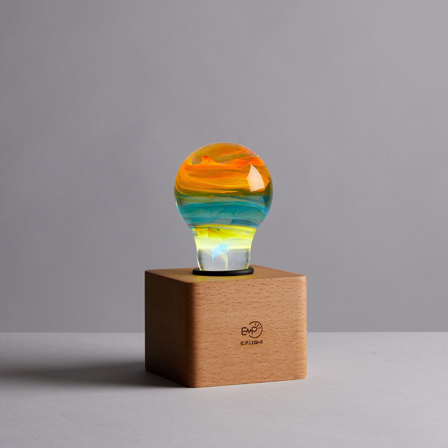 Solar Systeam Table Lamp featuring eco-friendly resin and beech wood, available in mixed colors.