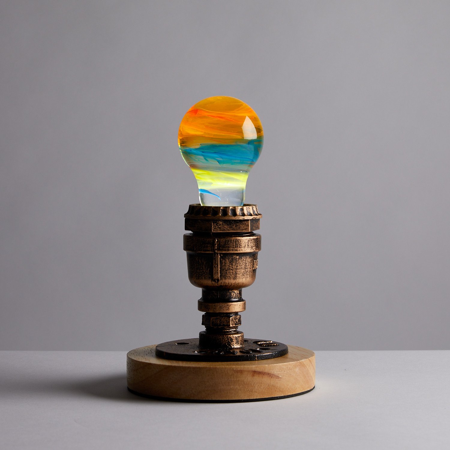 Solar Systeam Table Lamp featuring eco-friendly resin and beech wood, available in mixed colors.