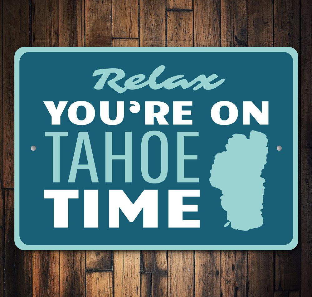 A decorative Tahoe Time Sign made of aluminum, showcasing a beautiful lakeside theme, perfect for lakehouses.