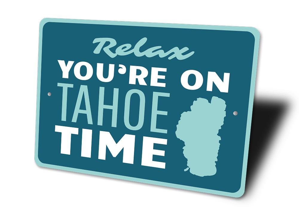 A decorative Tahoe Time Sign made of aluminum, showcasing a beautiful lakeside theme, perfect for lakehouses.