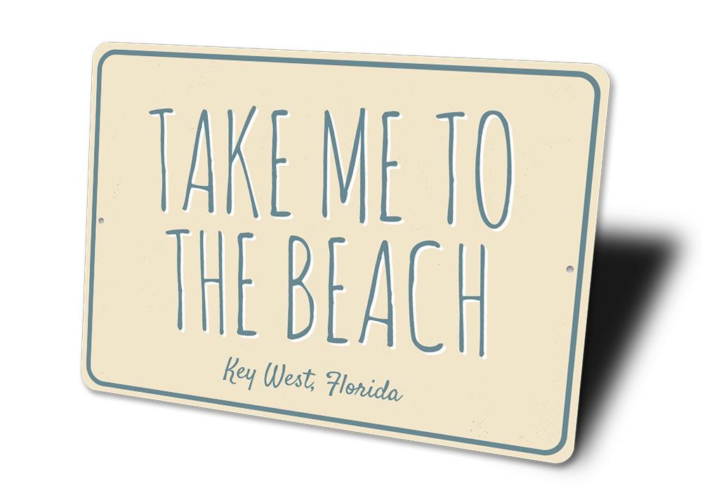 A decorative 'Take Me To The Beach' sign made of high-quality aluminum, featuring beach-themed graphics and customizable text options.