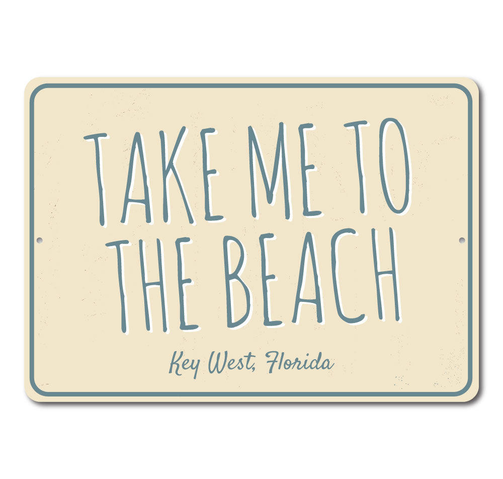 A decorative 'Take Me To The Beach' sign made of high-quality aluminum, featuring beach-themed graphics and customizable text options.