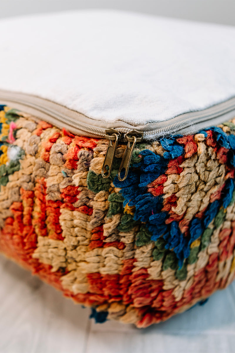 Take Me To Tunis Berber Pillow, 28x28 inches, featuring vibrant orange, blue, and yellow colors, handmade from vintage wool rug.