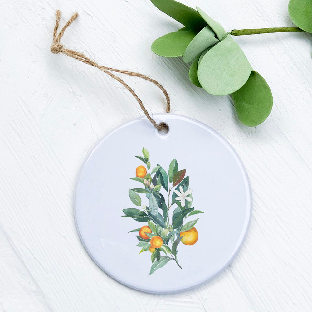 A beautifully designed Tangerine Branch Ornament made of high-quality porcelain, featuring vibrant colors and a glossy finish.