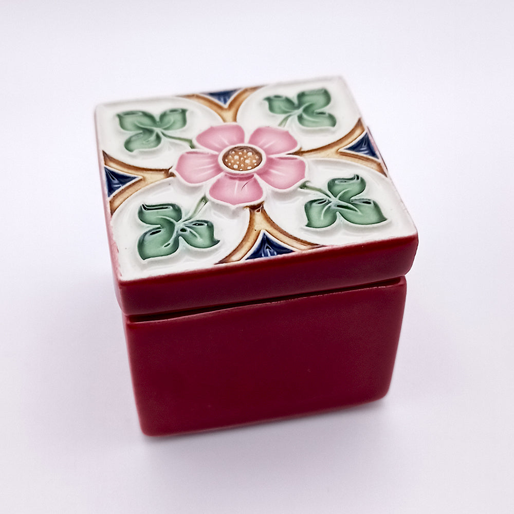 A beautifully handcrafted Tavira Ceramic Box with vibrant colors and whimsical designs, showcasing intricate details.