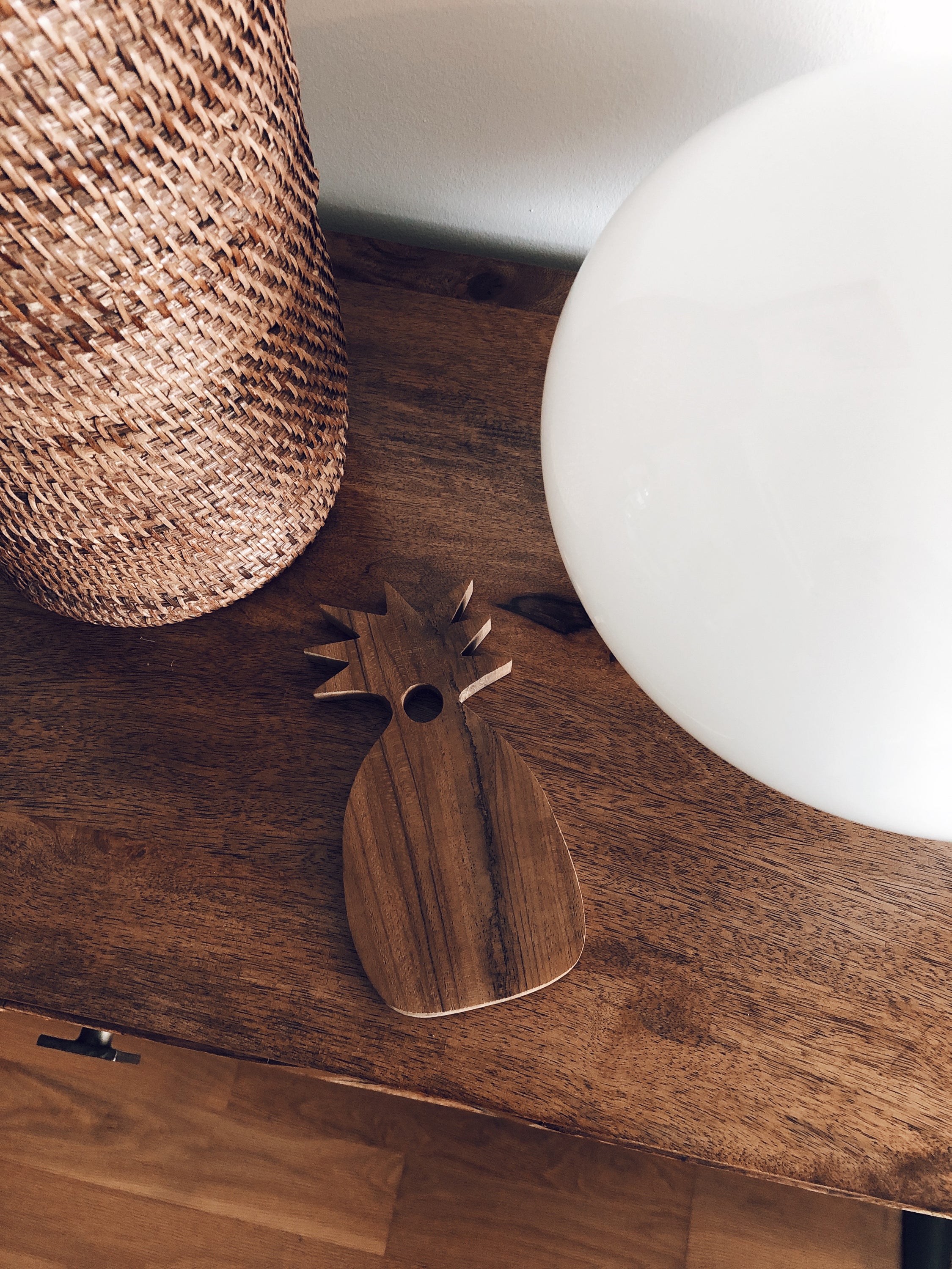 Teak wood serving plate shaped like a pineapple, showcasing its unique design and natural wood grain.